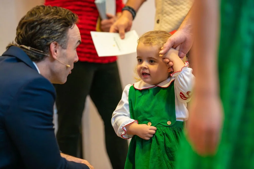 Lead Pastor John Bourgeois greets a church member's daughter in the hallway on Sunday at West End Community Church in Nashville, TN