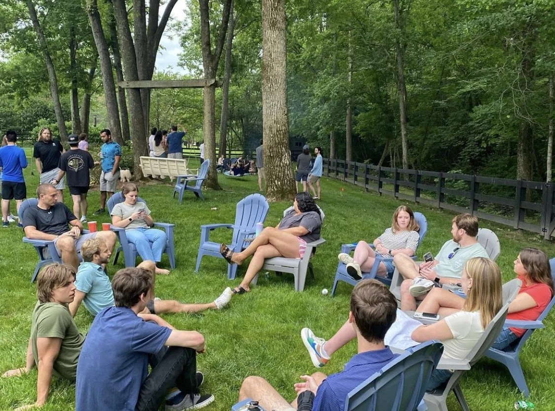 young adults lounging at a backyard party