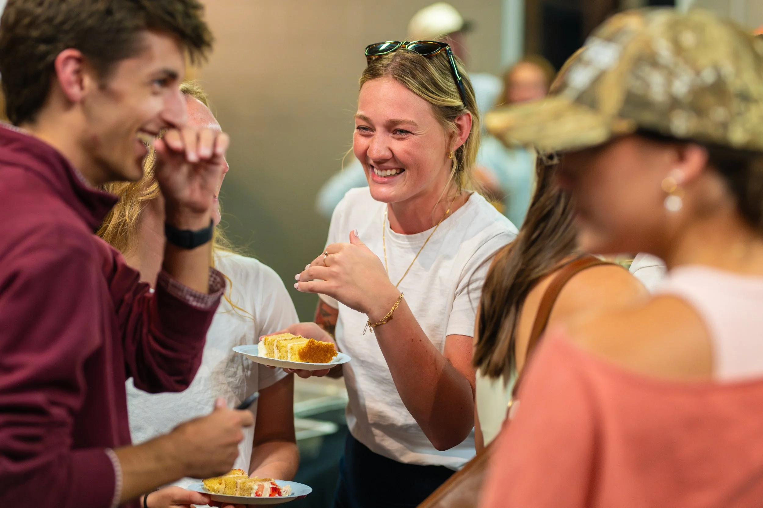 Young adults enjoying dinner together during a party in the Hanger