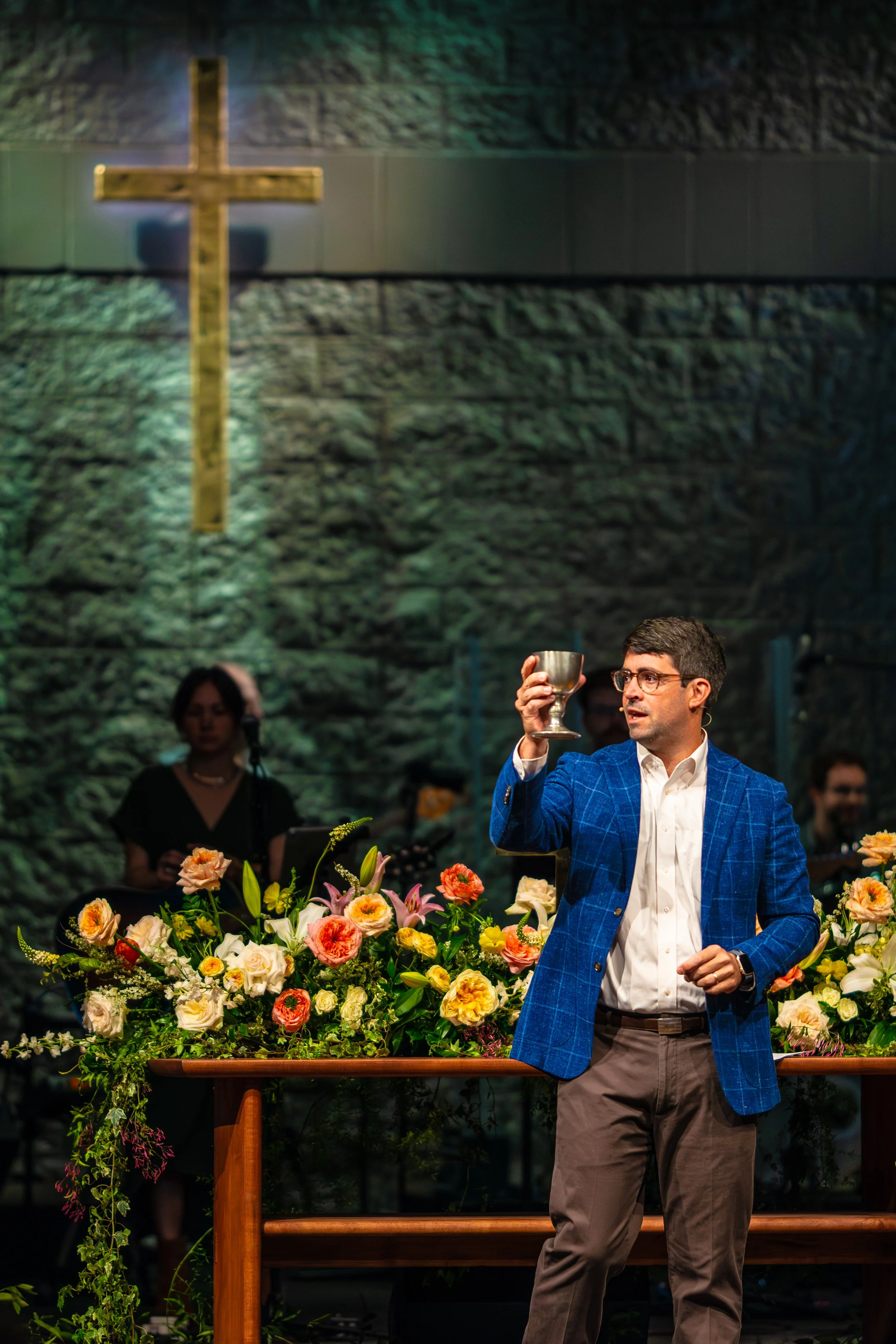 Pastor Stewart Swain raising the cup during The Lord's Supper sacrament