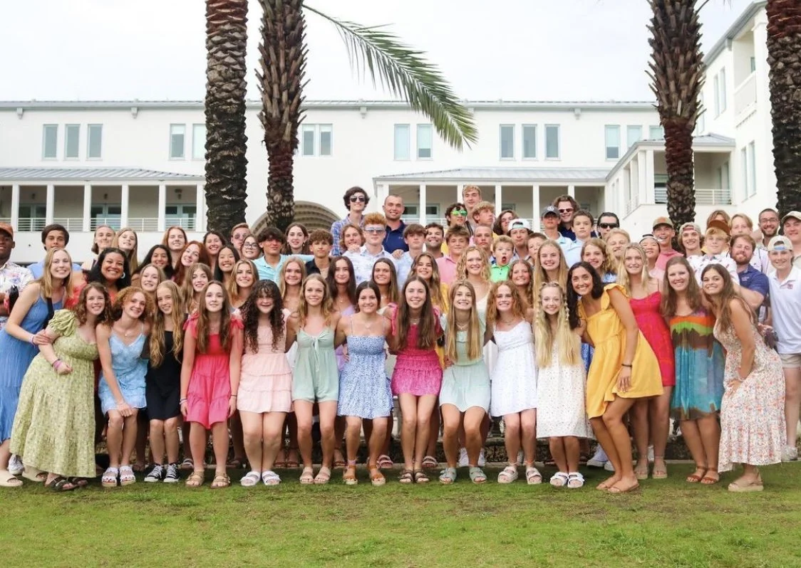 Large group photo of all the high school students attending the RYM retreat at the beach