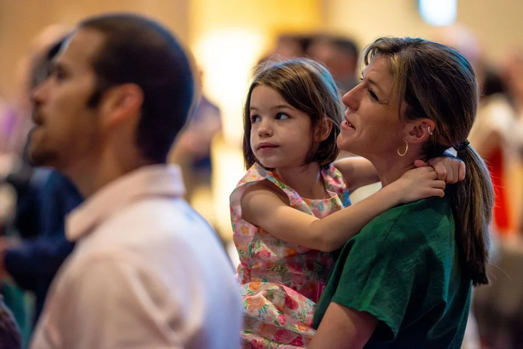 A mother enjoys worship service with her young daughter at West End Community Church in Nashville, TN