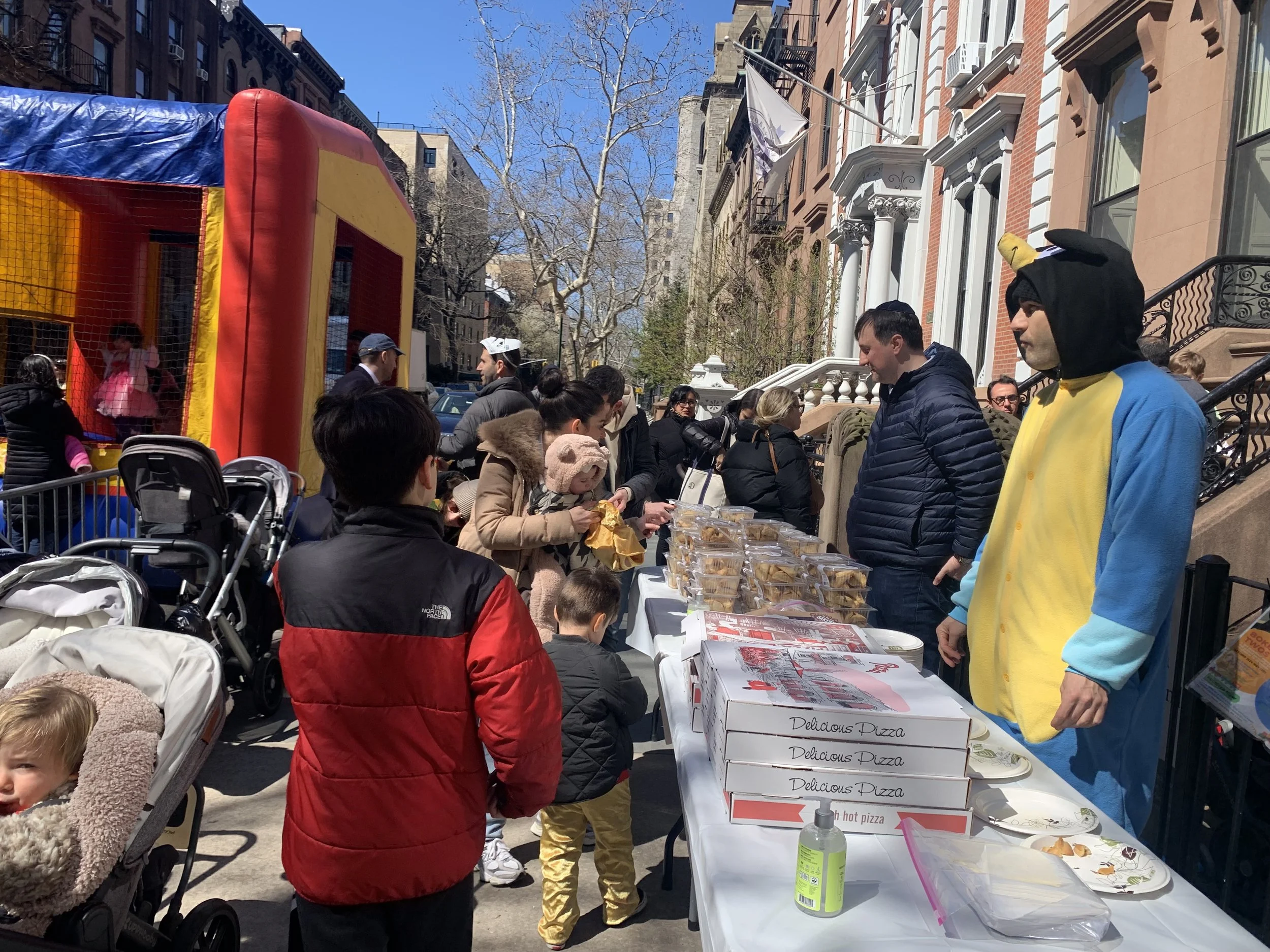 congregants enjoy food at the outdoor purim carnival