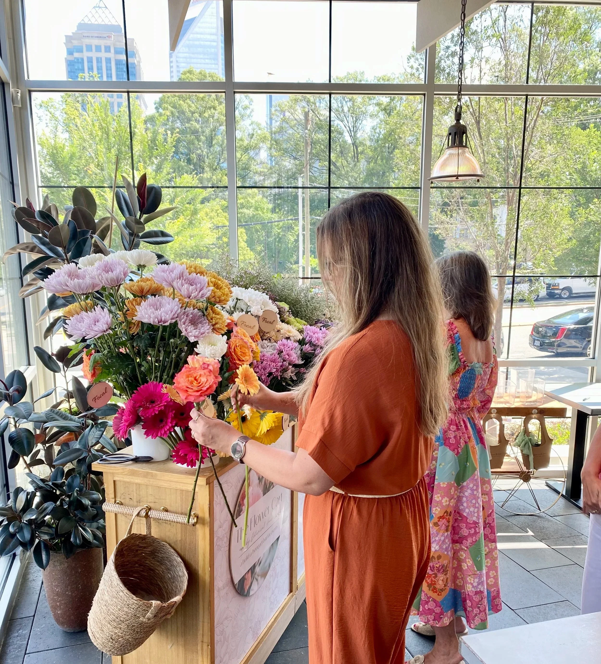 a women at a bouquet bar at sixty vines in charlotte