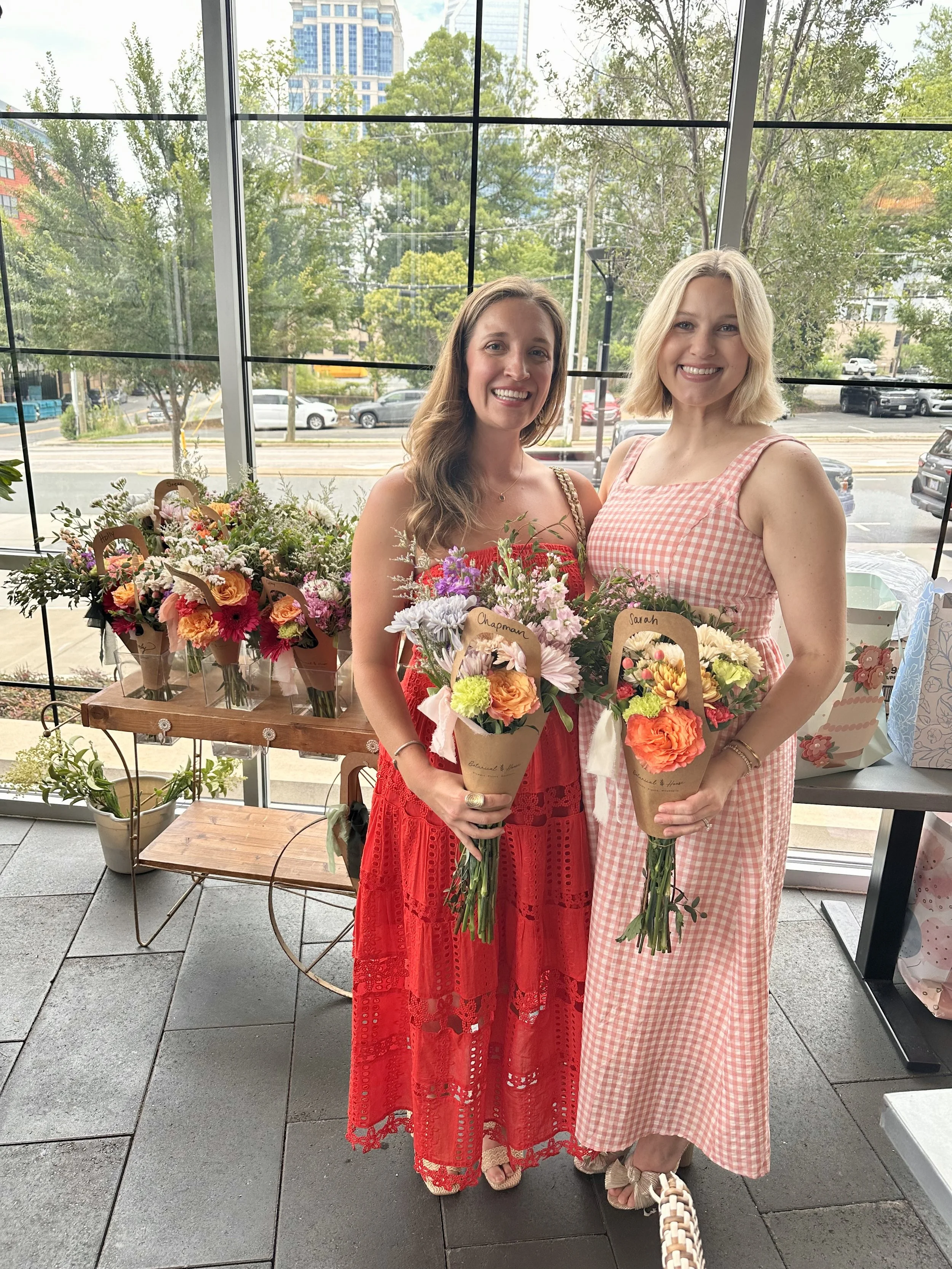 Two women at a build-a-bouquet bar with custom made bouquets