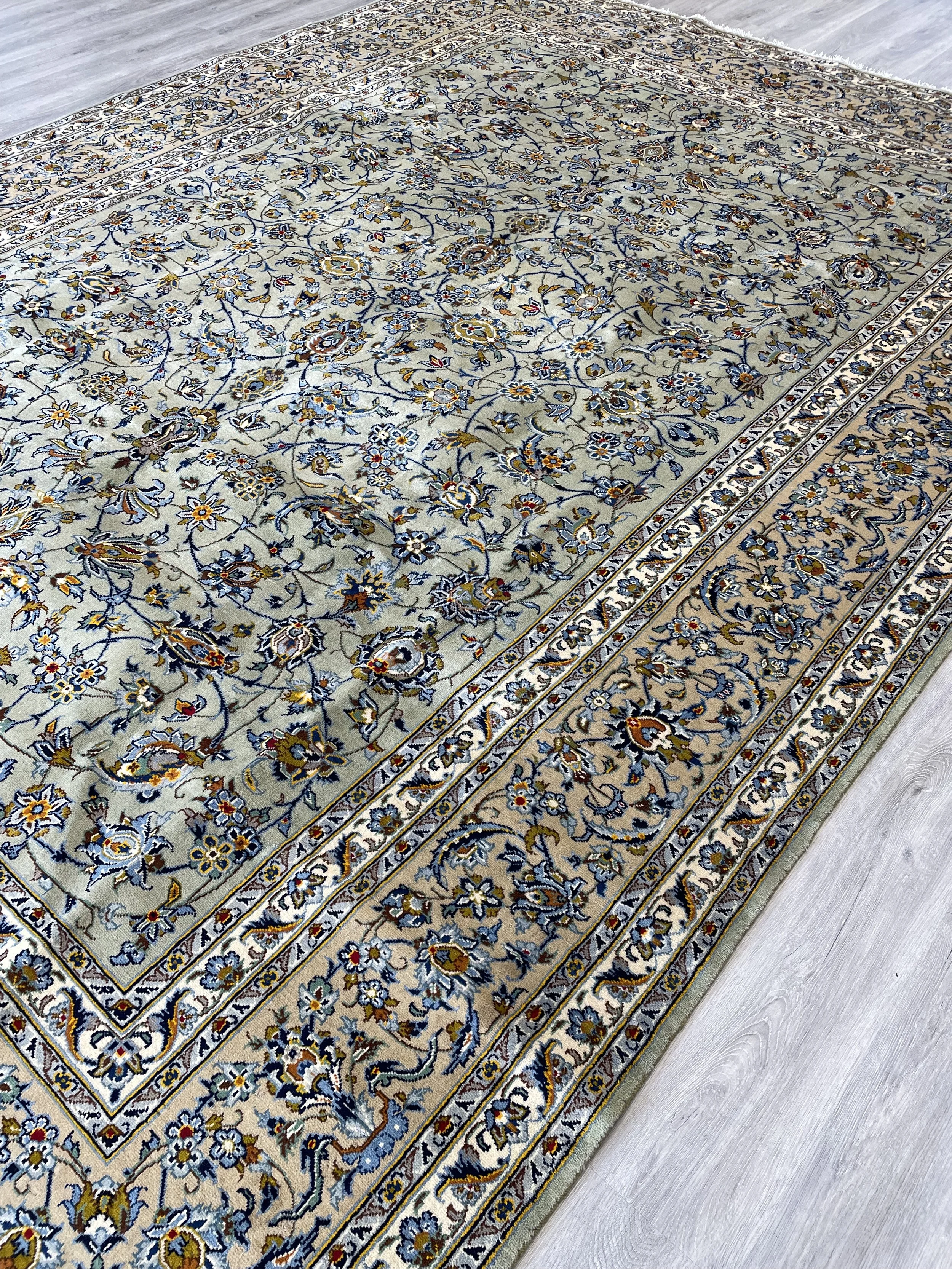 Handmade 9x12 Kashan wool rug featuring an all-over pattern in a pistachio green colour combination
