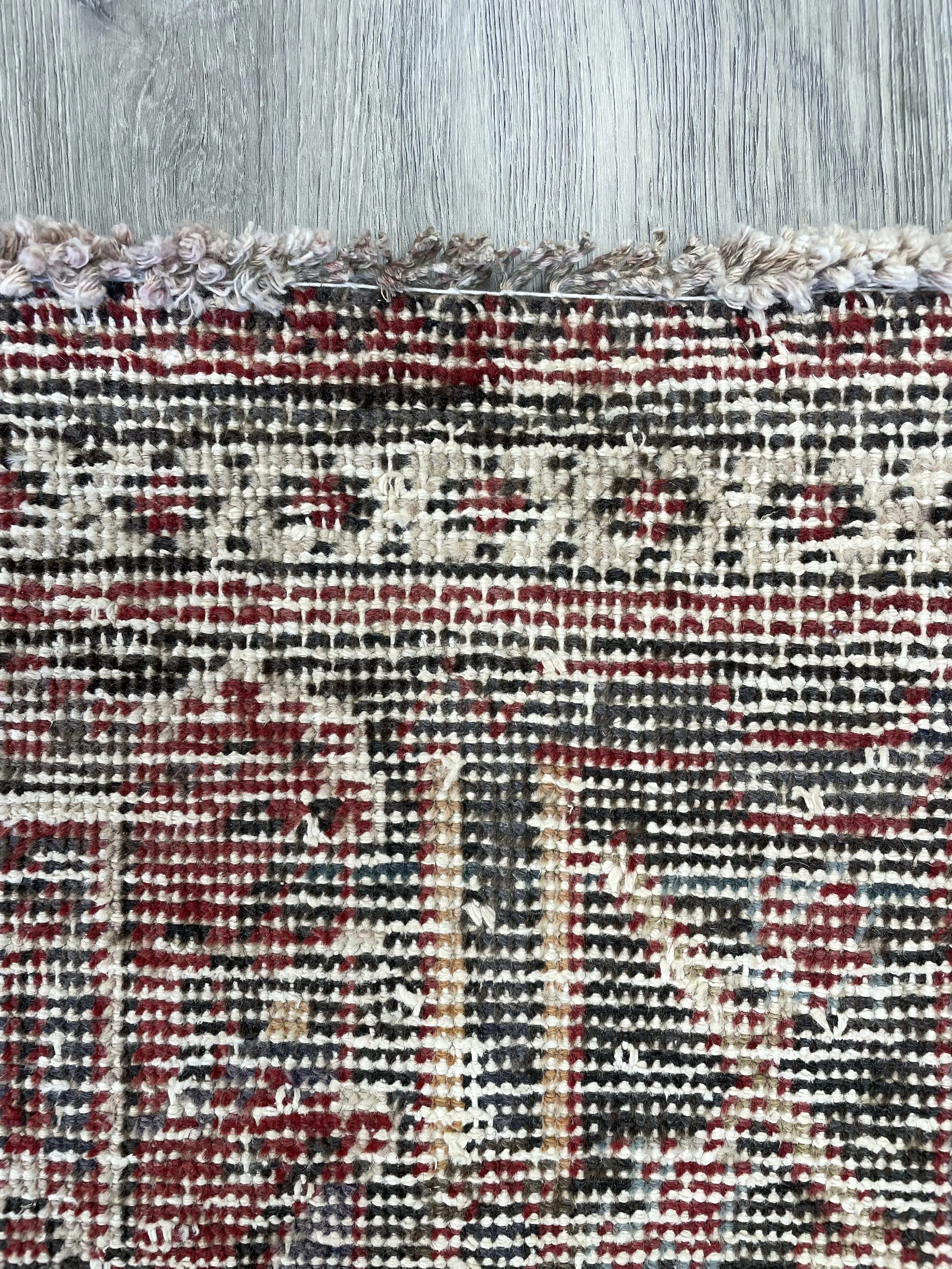 A handmade Joshaghan tribal wool vintage rug in a distressed colour combination.