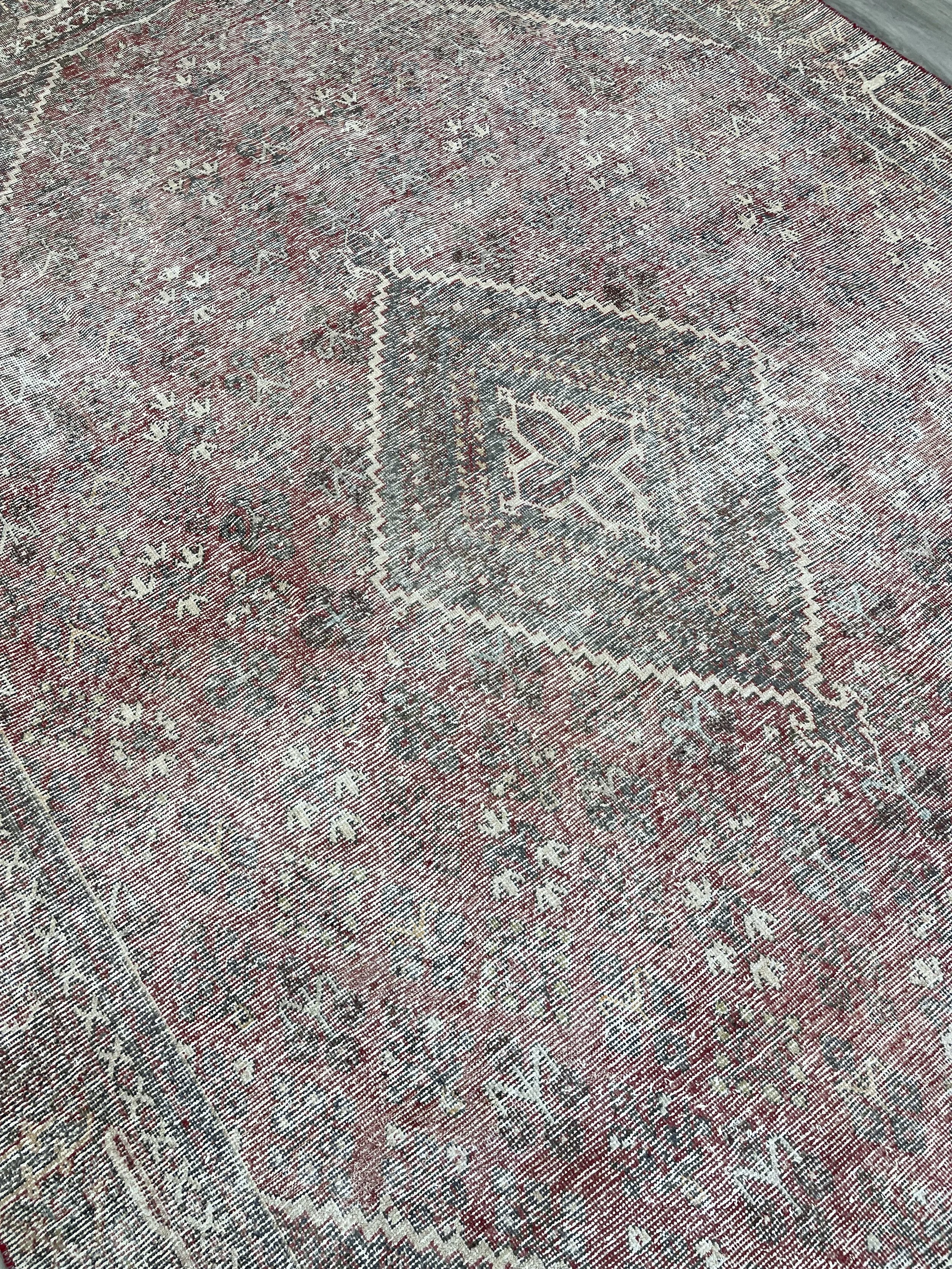 A handmade Joshaghan tribal wool vintage rug in a distressed colour combination.