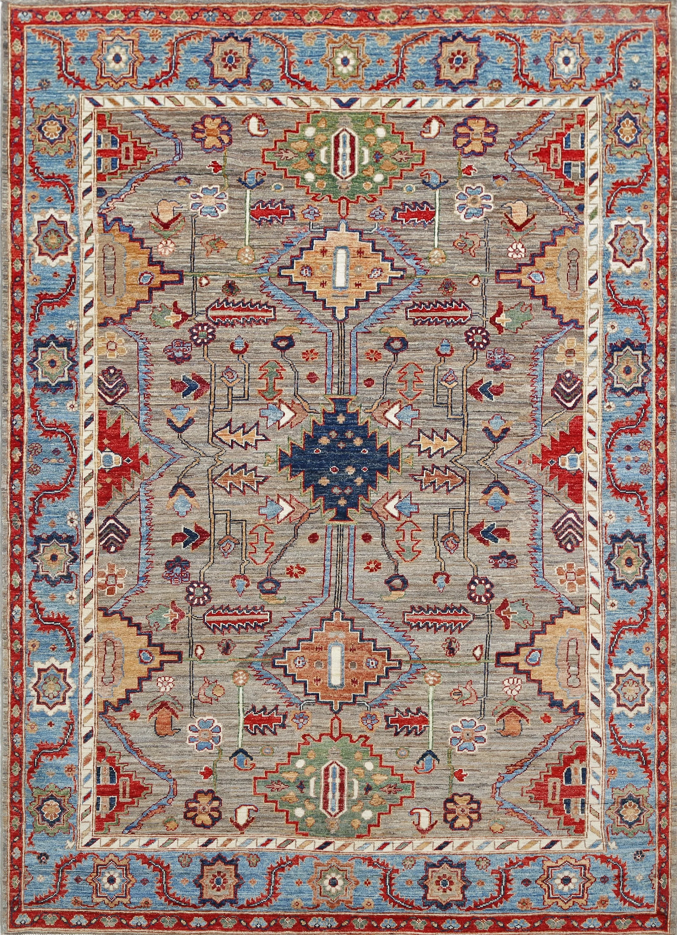 A hand-knotted Serapi design 6x9 wool rug featuring a colourful geometric design.