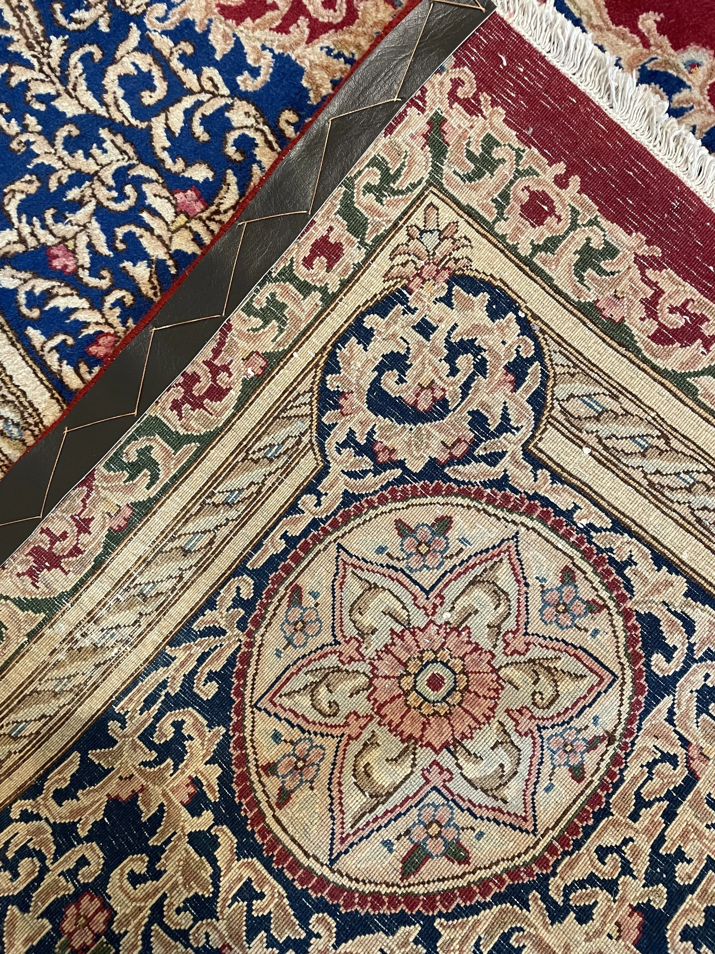 A hand-knotted Kerman 10x13 semi-antique Persian rug made with wool.