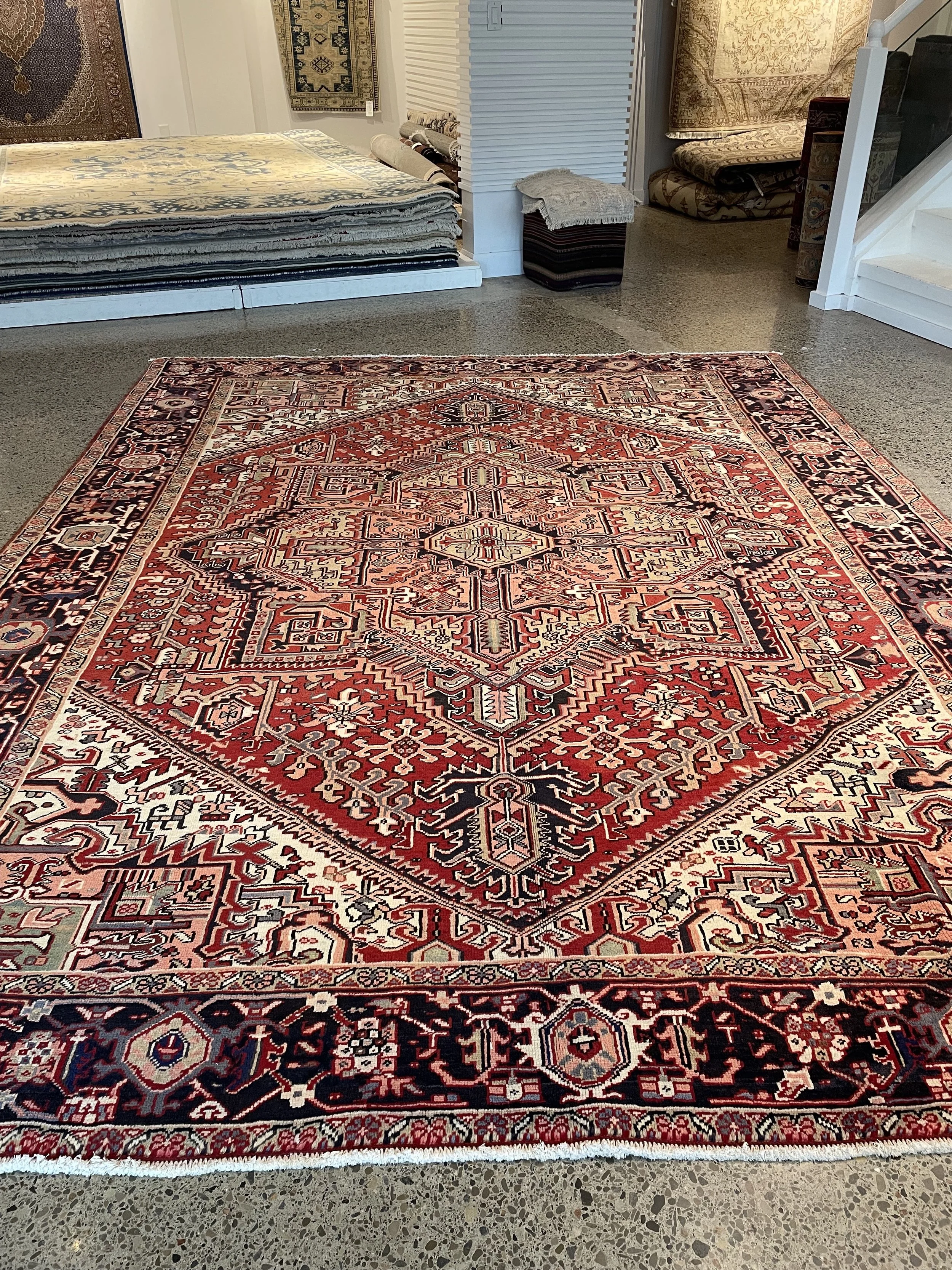 A hand-knotted Heriz 8x11 wool rug.