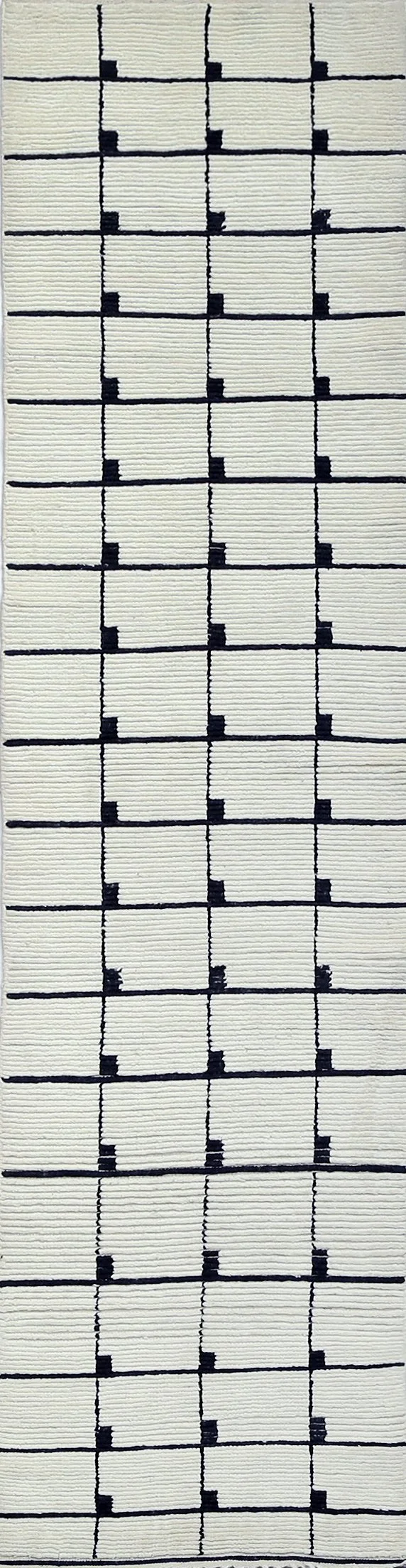 A hand-knotted Moroccan-style modern wool rug runner measuring approximately 10 feet long.