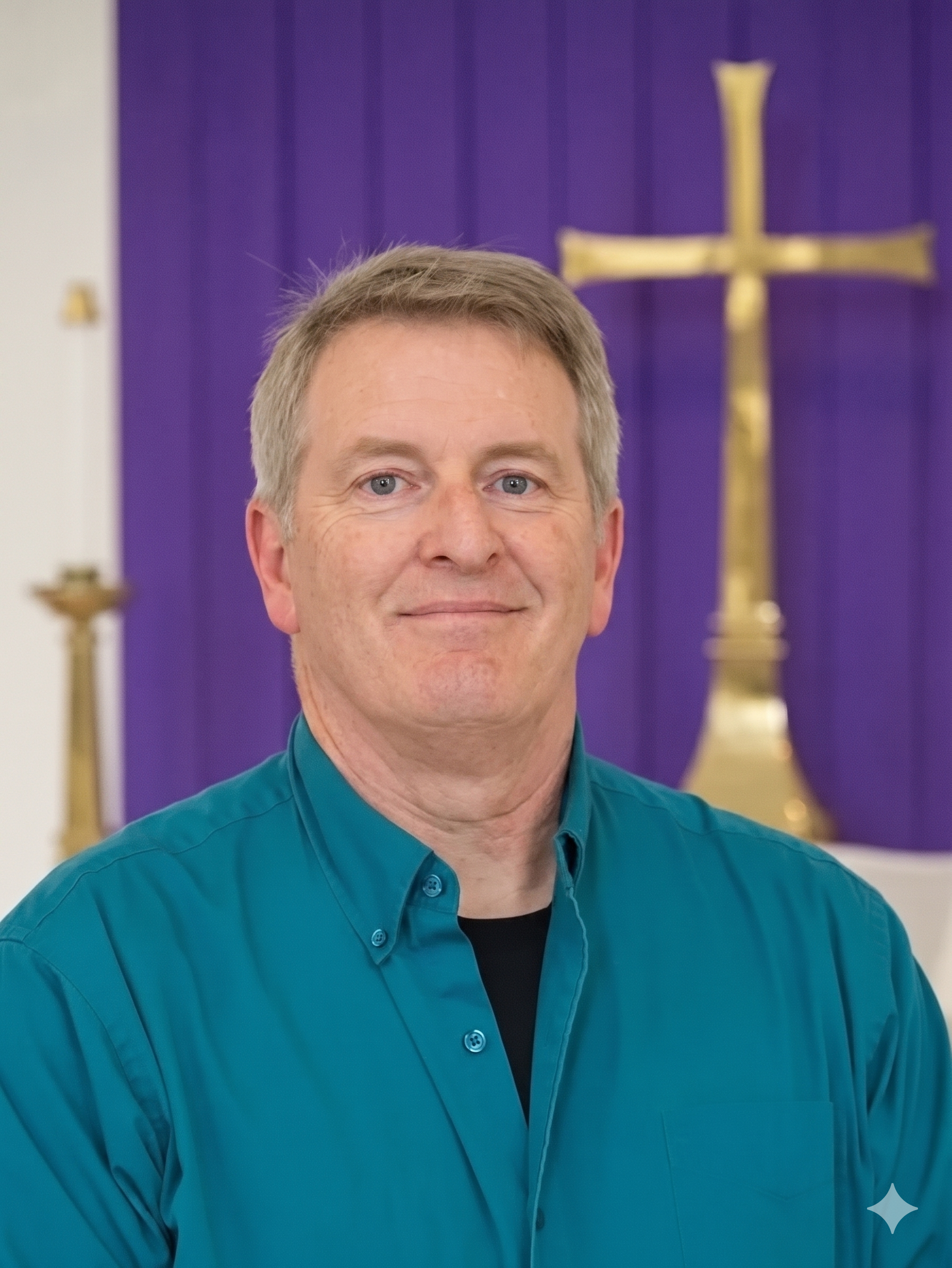 Portrait of an older man with grey hair and a serious expression in a green collared shirt standing indoors in front of a chancel with a gold cross and purple fabric.
