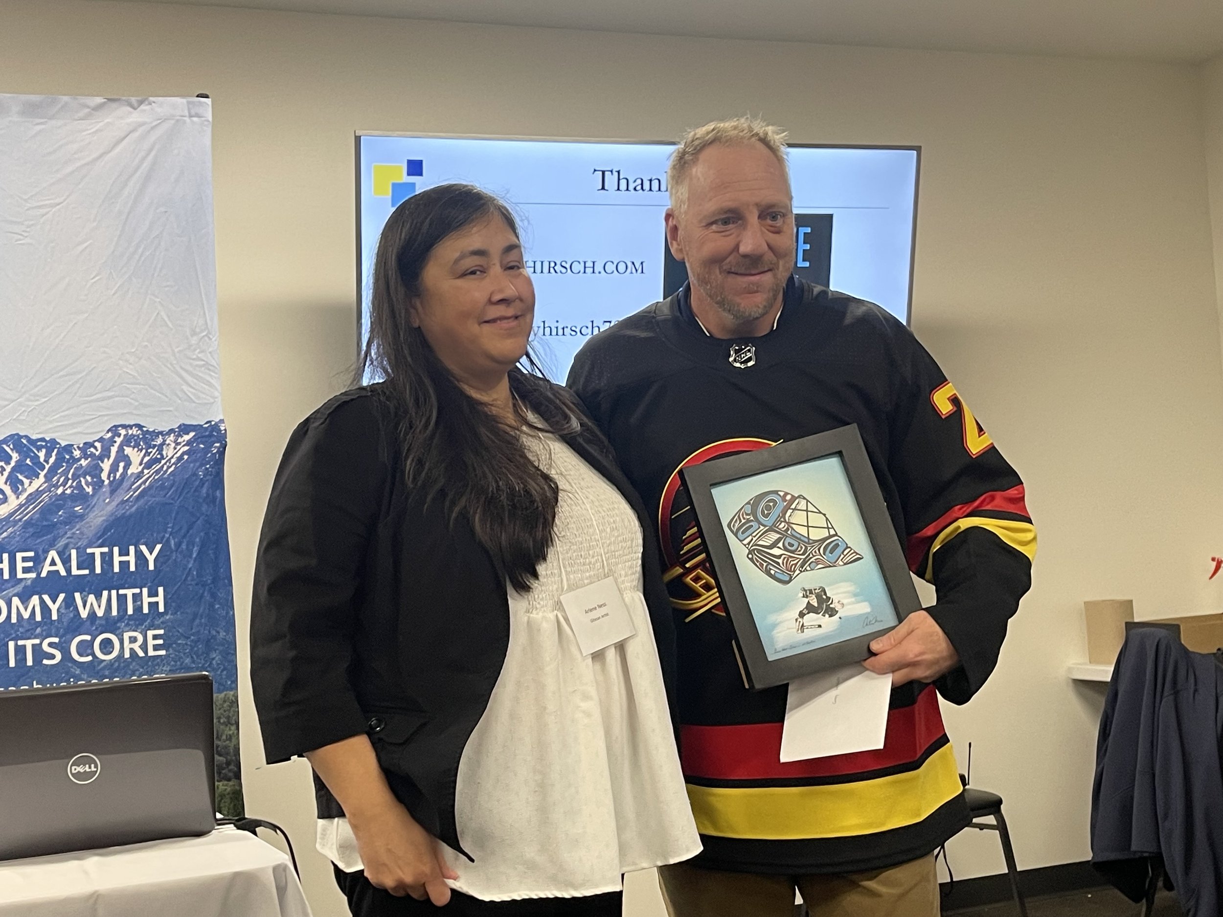 Arlene Ness presents her artwork to Corey Hirsch