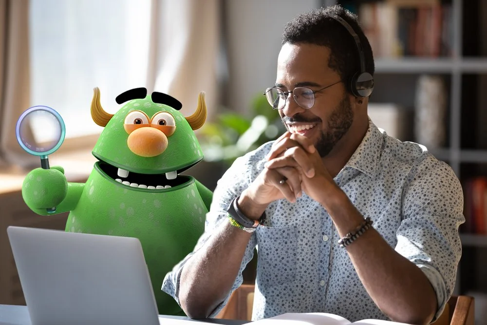 man working laptop with headphones - happy with mag glass.jpg