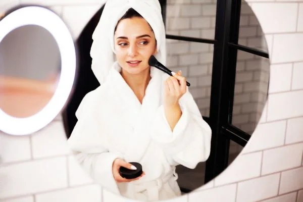 Bride doing her own makeup before ceremony