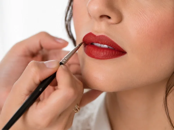 Makeup artist applying precise vintage bridal lip