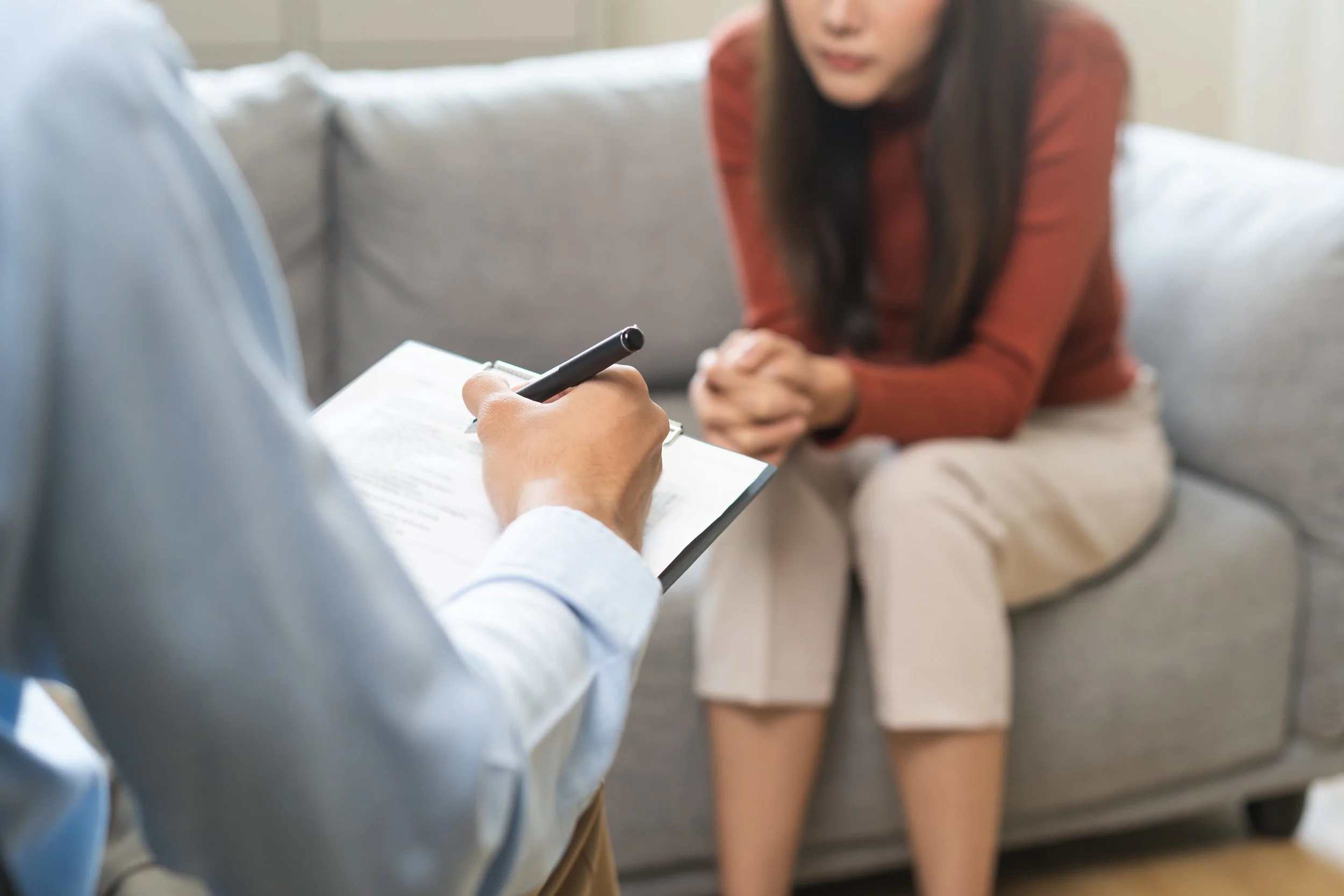 therapist making notes during CBT session