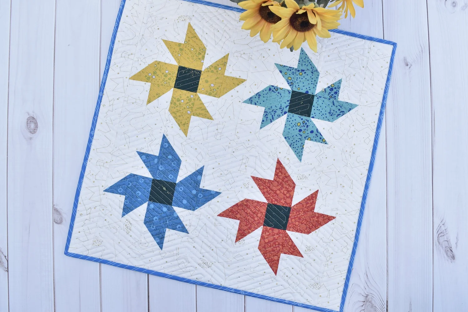 "Wildflowers Table Topper" is a Free Summer Quilted Table Top Pattern designed by Amanda from Material Girl Quilts!