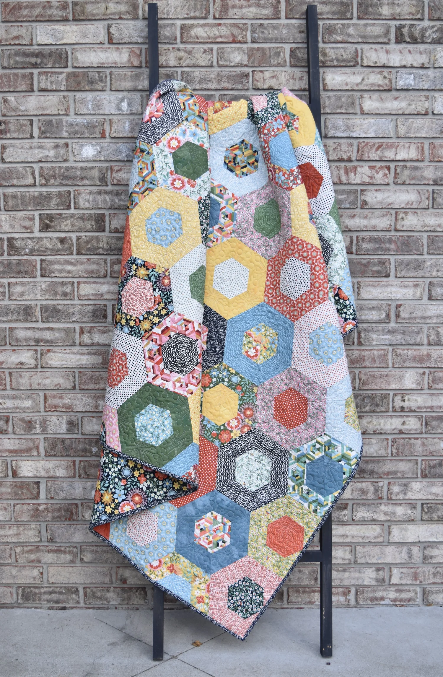 "Hexaround" is a Free Jelly Roll Lap Quilt Pattern designed by Amanda Castor from Material Girl Quilts!
