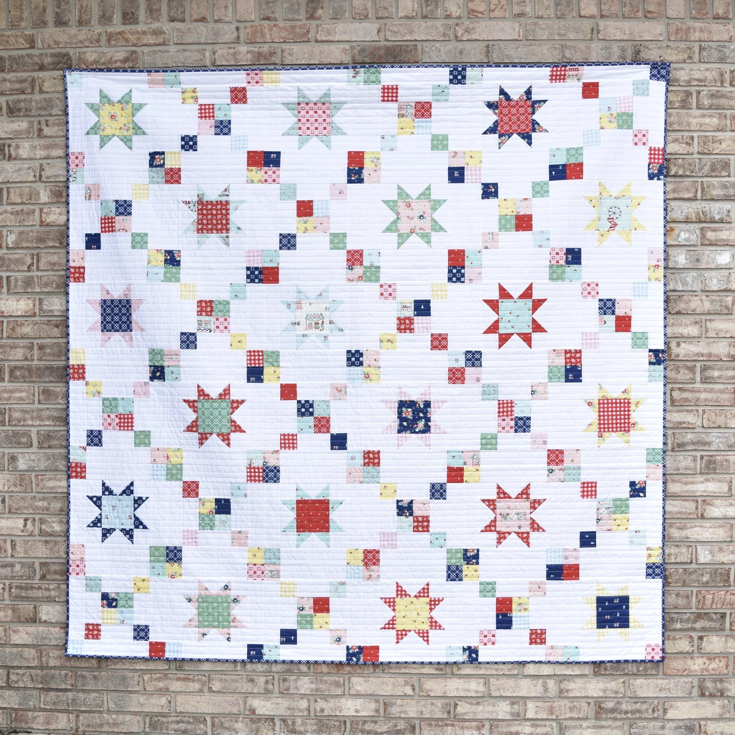 "Star Chain" is a Free Layer Cake Quilt Pattern designed by Amanda from Material Girl Quilts!