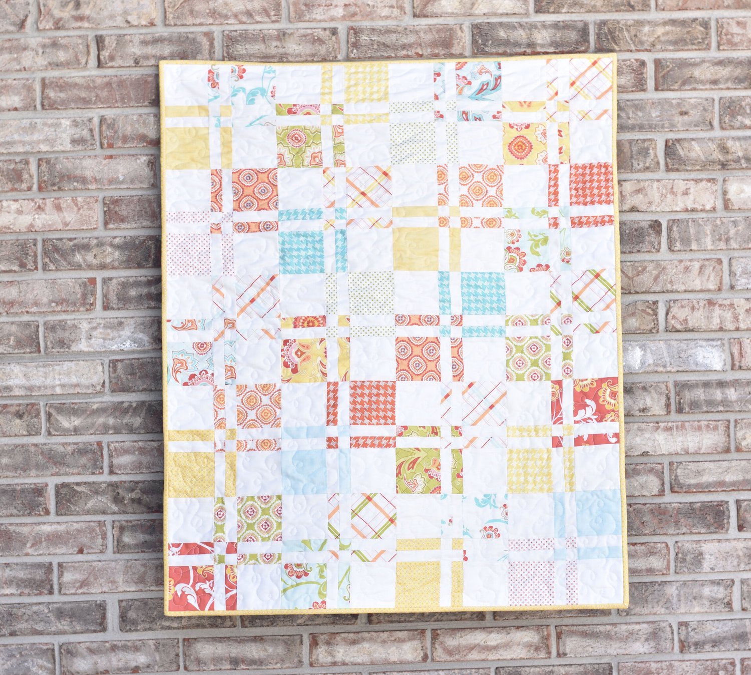 "Disappearing Four Patch” is a Free Charm Square Baby Quilt Pattern designed by Amanda from Material Girl Quilts!