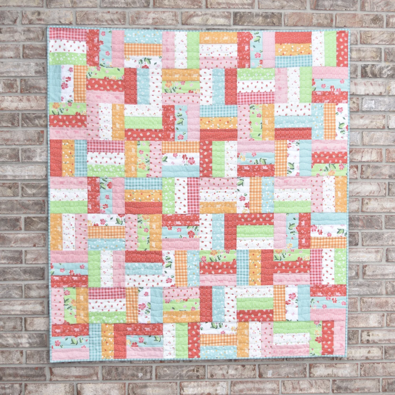 "Jelly Roll Rail Fence" is a Free Jelly Roll Lap Quilt Pattern designed by Amanda Castor from Material Girl Quilts!