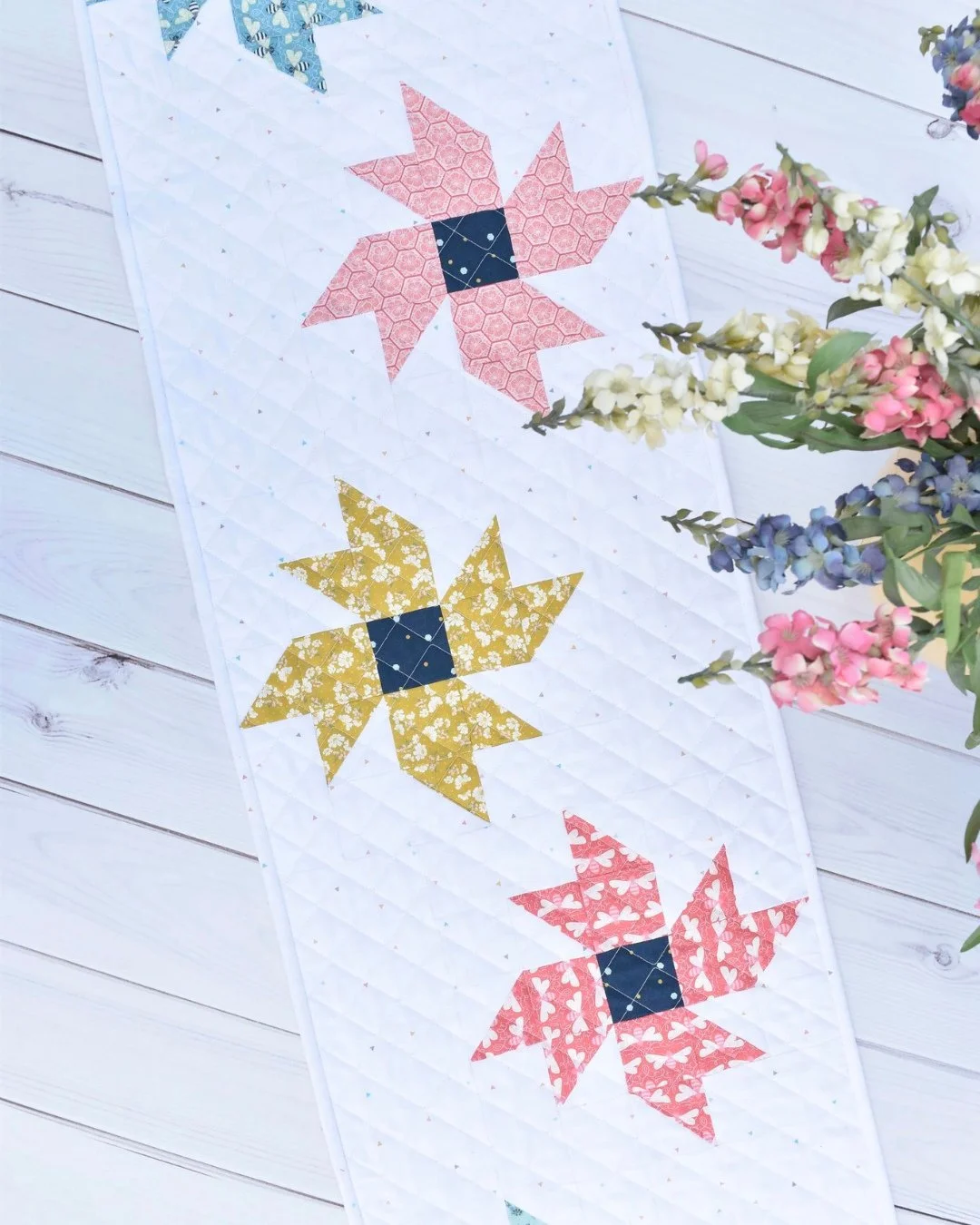 If you are in the mood for something bright and happy, this Wildflowers table topper is calling your name!💐 The star blocks totally read like little flowers scattered across the table, and with multiple size options you can make a runner or a topper