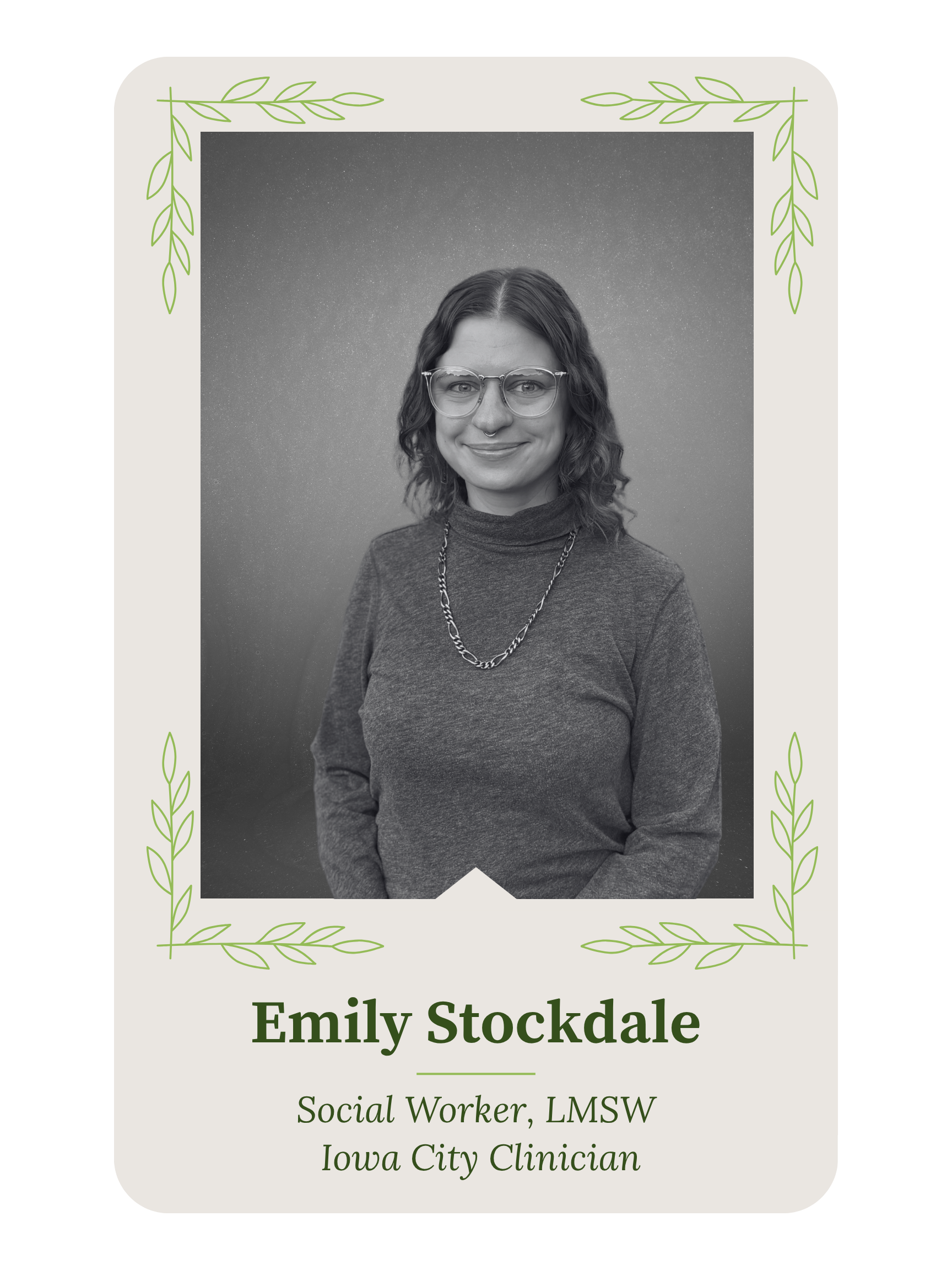 Name tag with a black and white photo of a woman with shoulder-length hair, wearing a black top and a septum piercing, standing outdoors at night with a starry sky in the background. The tag reads: Emily Stockdale, Social Worker, LMSW, Iowa City clinician, framed with green leaf illustrations.