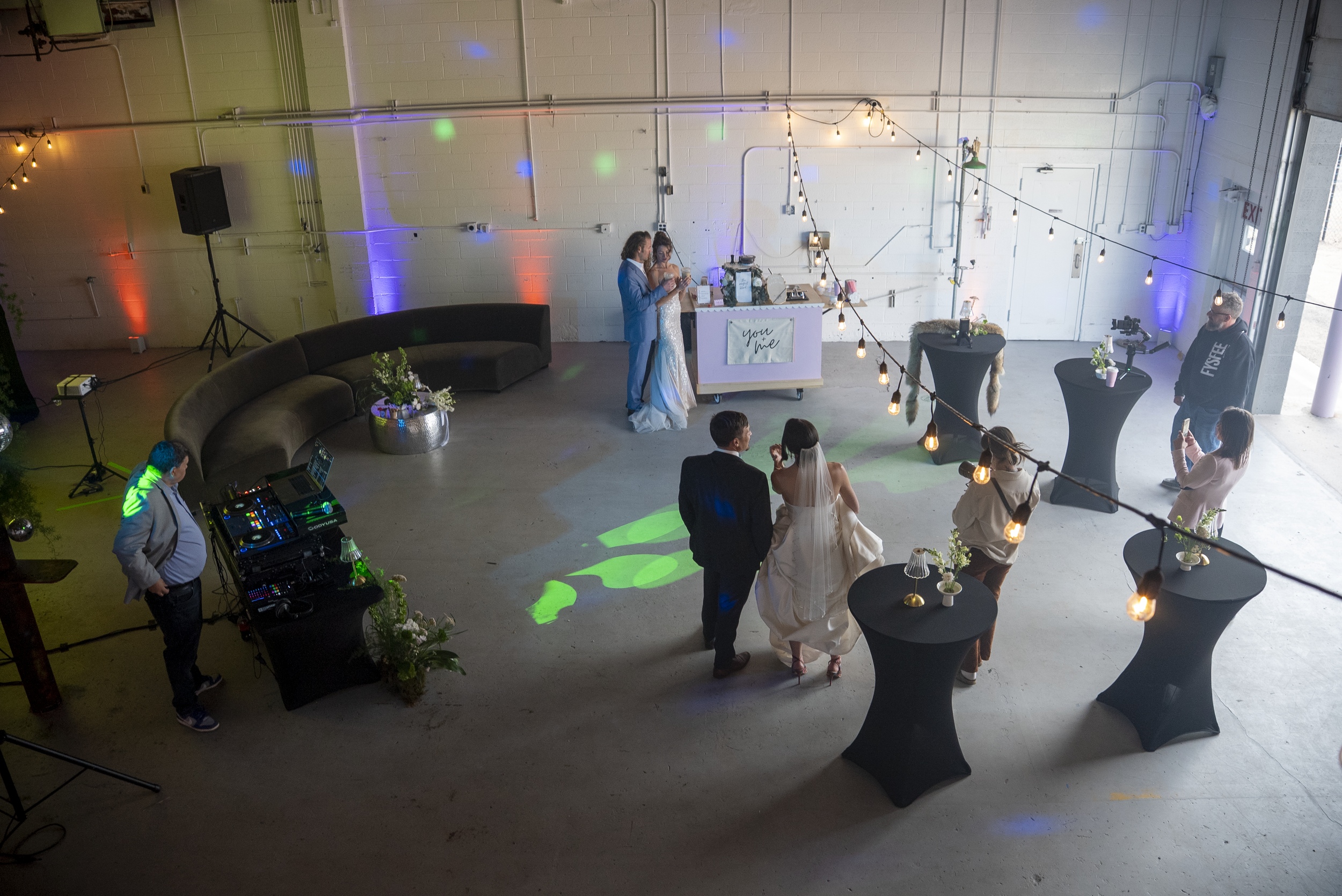 Guests at an evening wedding reception with colorful uplighting at Meanwhile Block