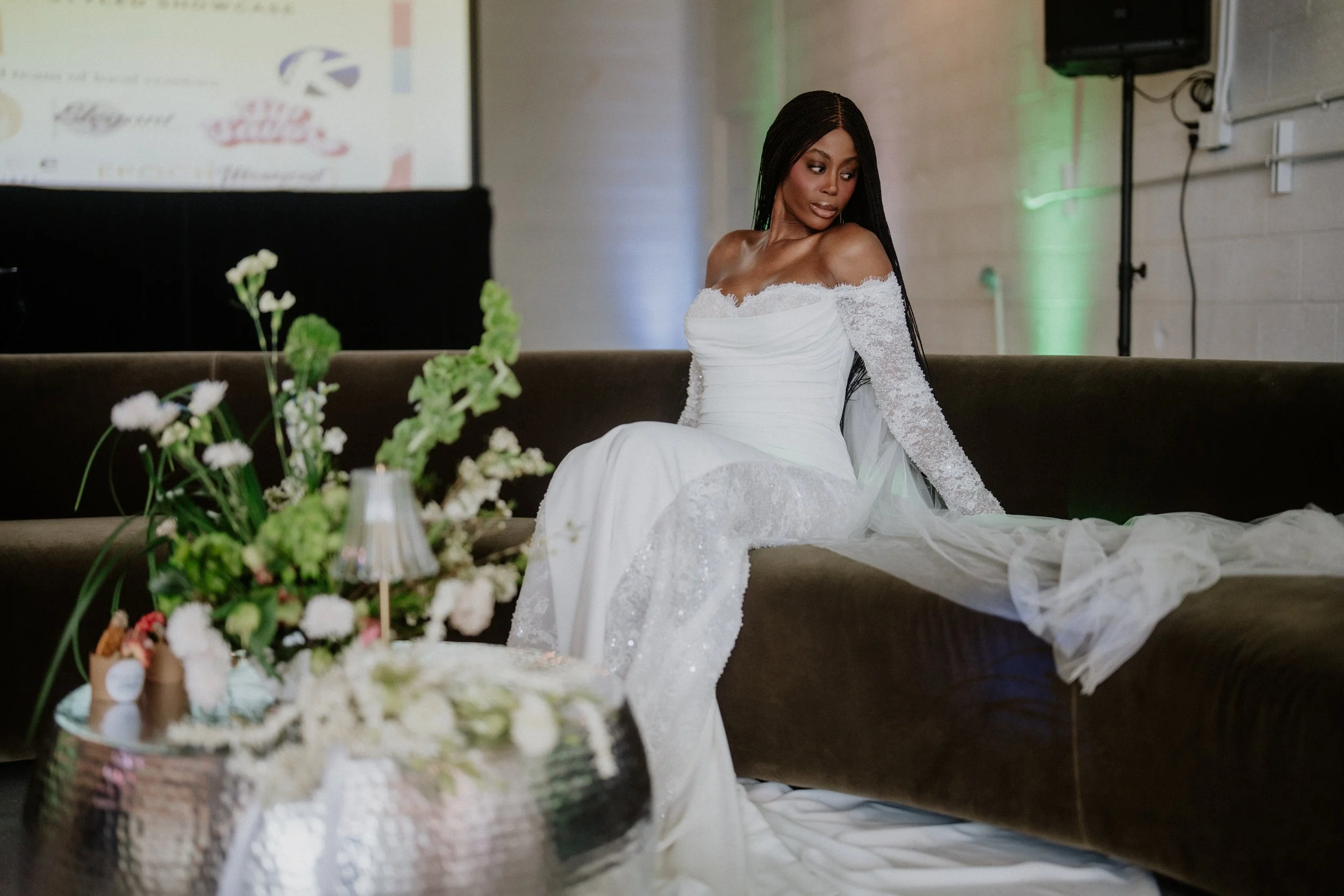 Bride lounging on a velvet sofa with white florals at Meanwhile Block