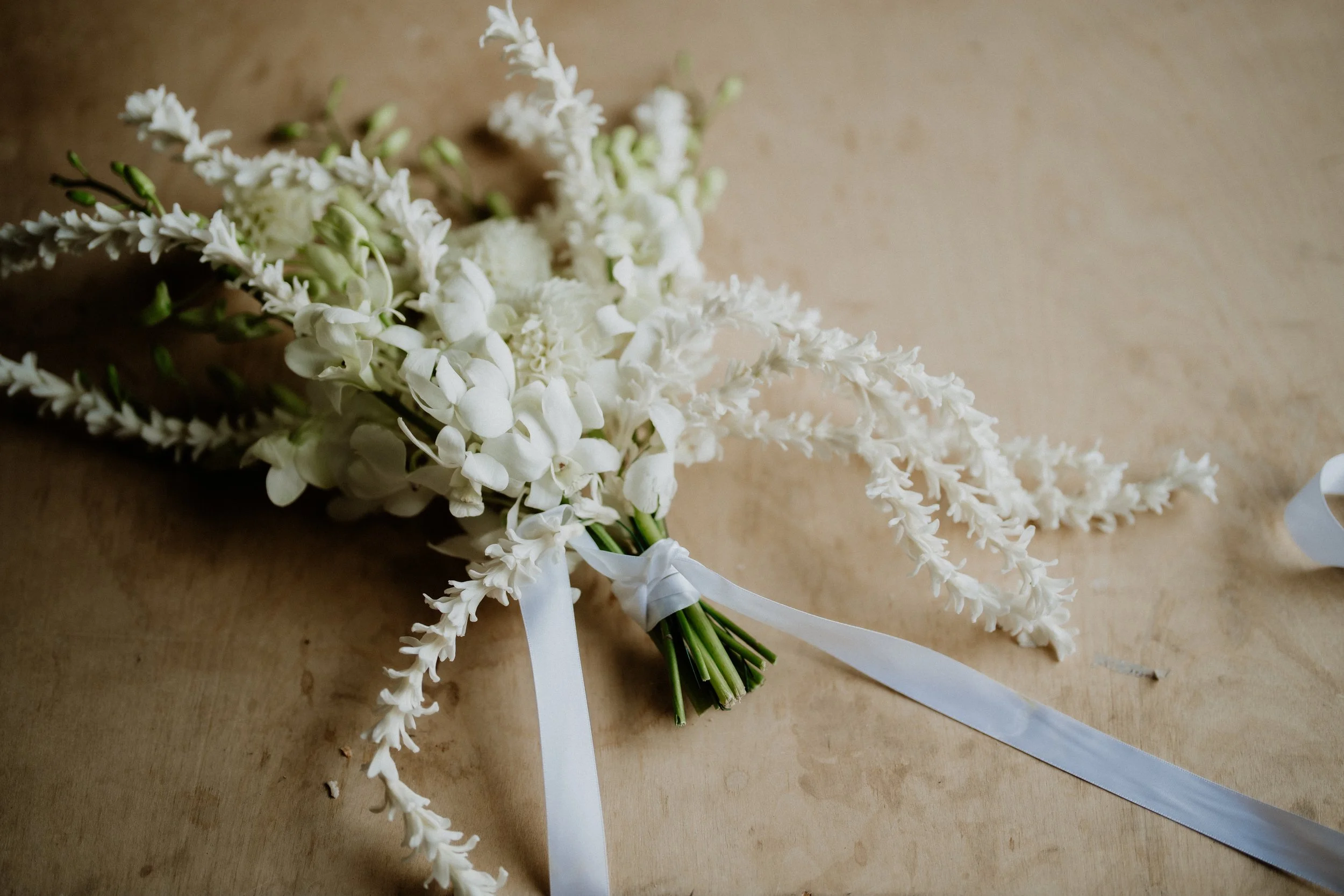 White bridal bouquet tied with ribbon