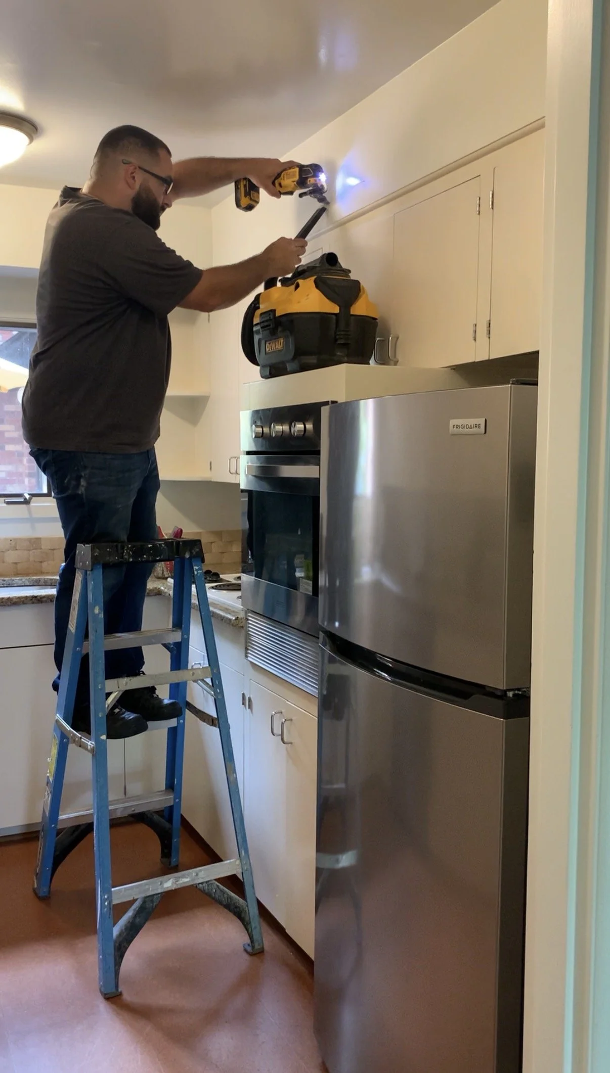 Right Angle Construction cuts into the kitchen soffit to explore what is behind it.