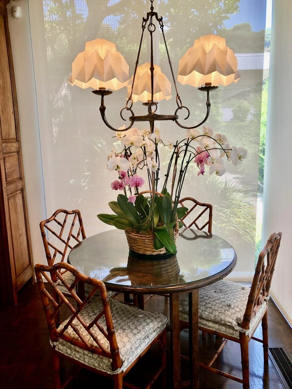 Table custom made from parquet flooring from French chateau. Chandelier is Louis XIII from Robert Minton, shades are custom made from Etsy. Chairs are British Chinoiserie.