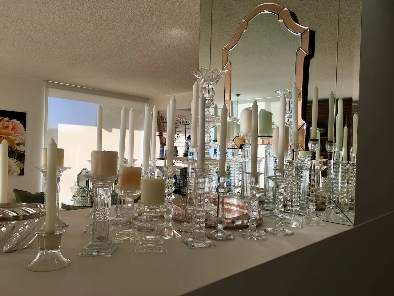 Crystal candlesticks are a mixture of contemporary and antique, various sources. Antique Venetian Mirror is hung on a custom paneled mirror mounted on the wall.