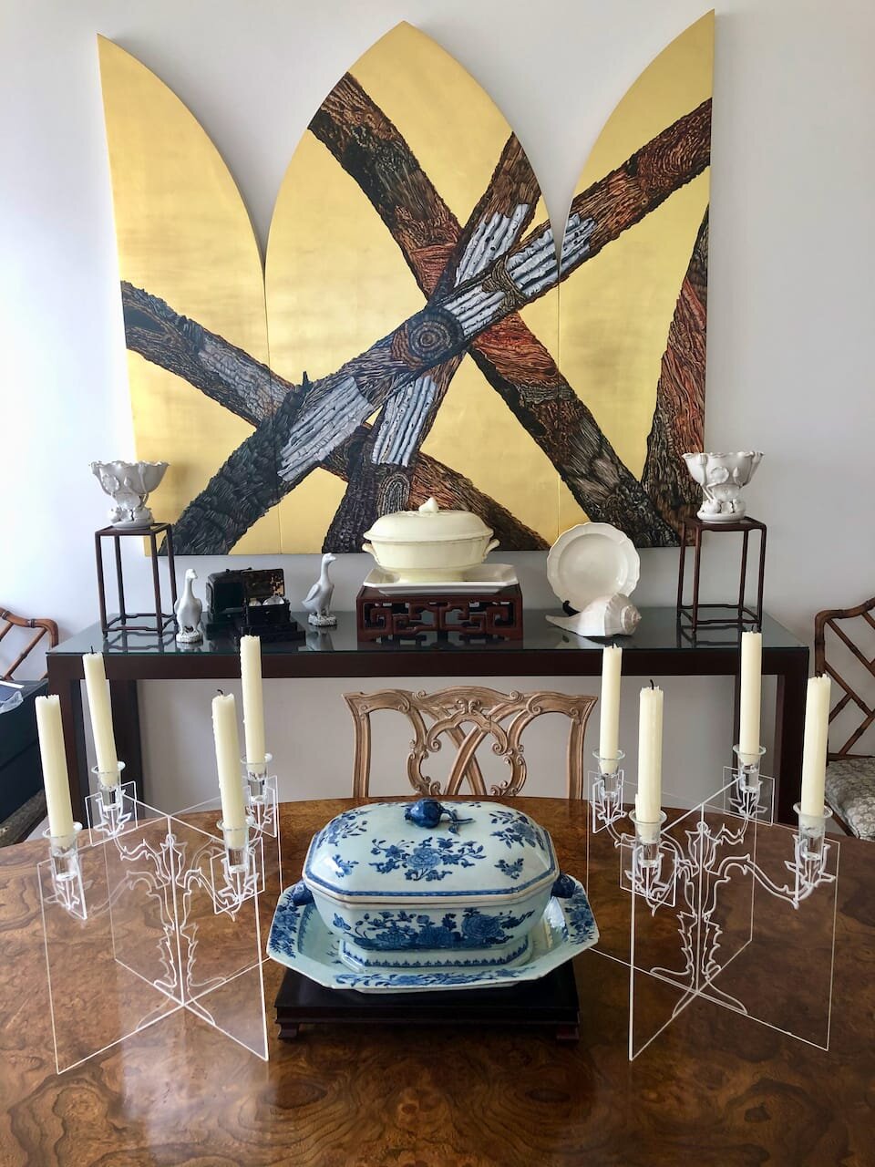 Dining room table is Florence Knoll walnut and stainless steel oval conference table from 1950s. Candelabras from MoMA. Chair is antique Irish Chippendale country dining chairs with velvet cushions, circa 1790.