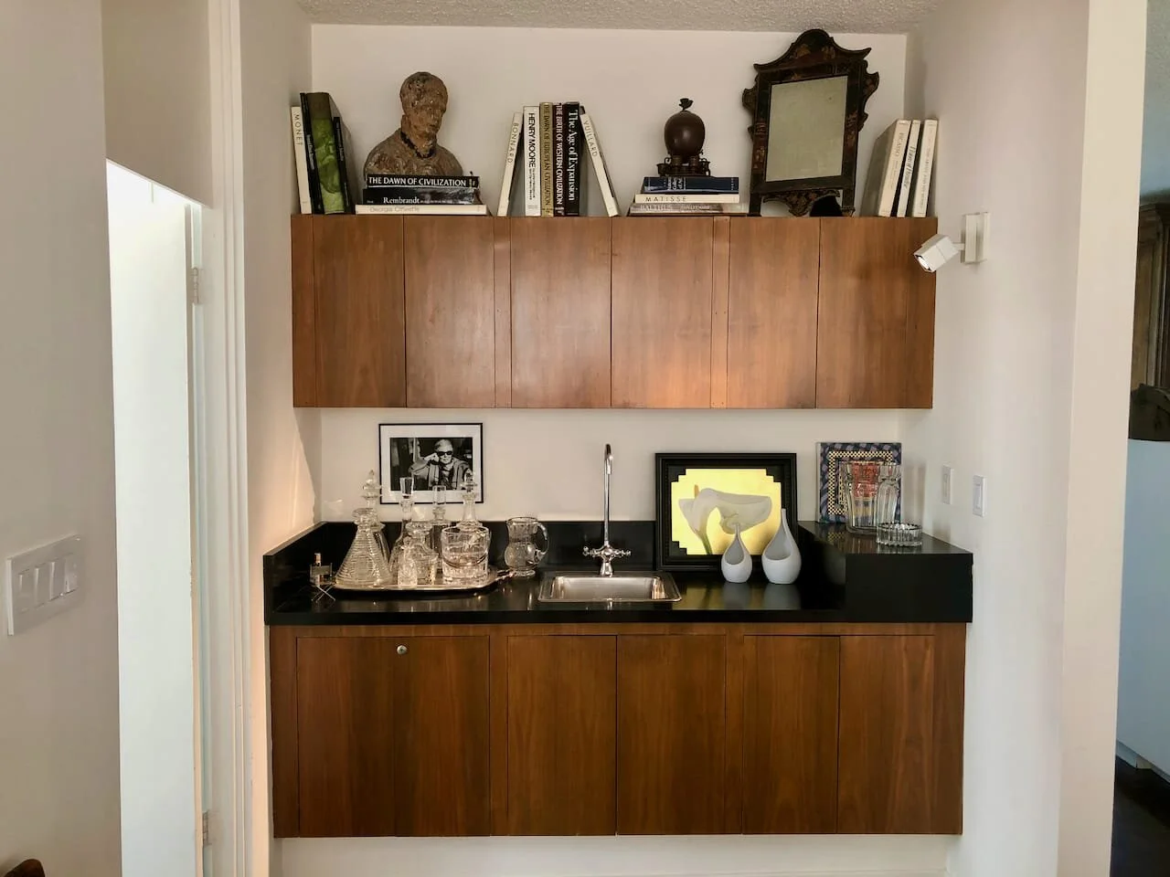 Mirror is antique Chinese gold and black lacquered dressing mirror, circa 1830. Santos figure is from South America. Crystal is a mixture of antique and contemporary English decanters. Vases designed by Stig Lindburgh in Sweden, circa 1950.