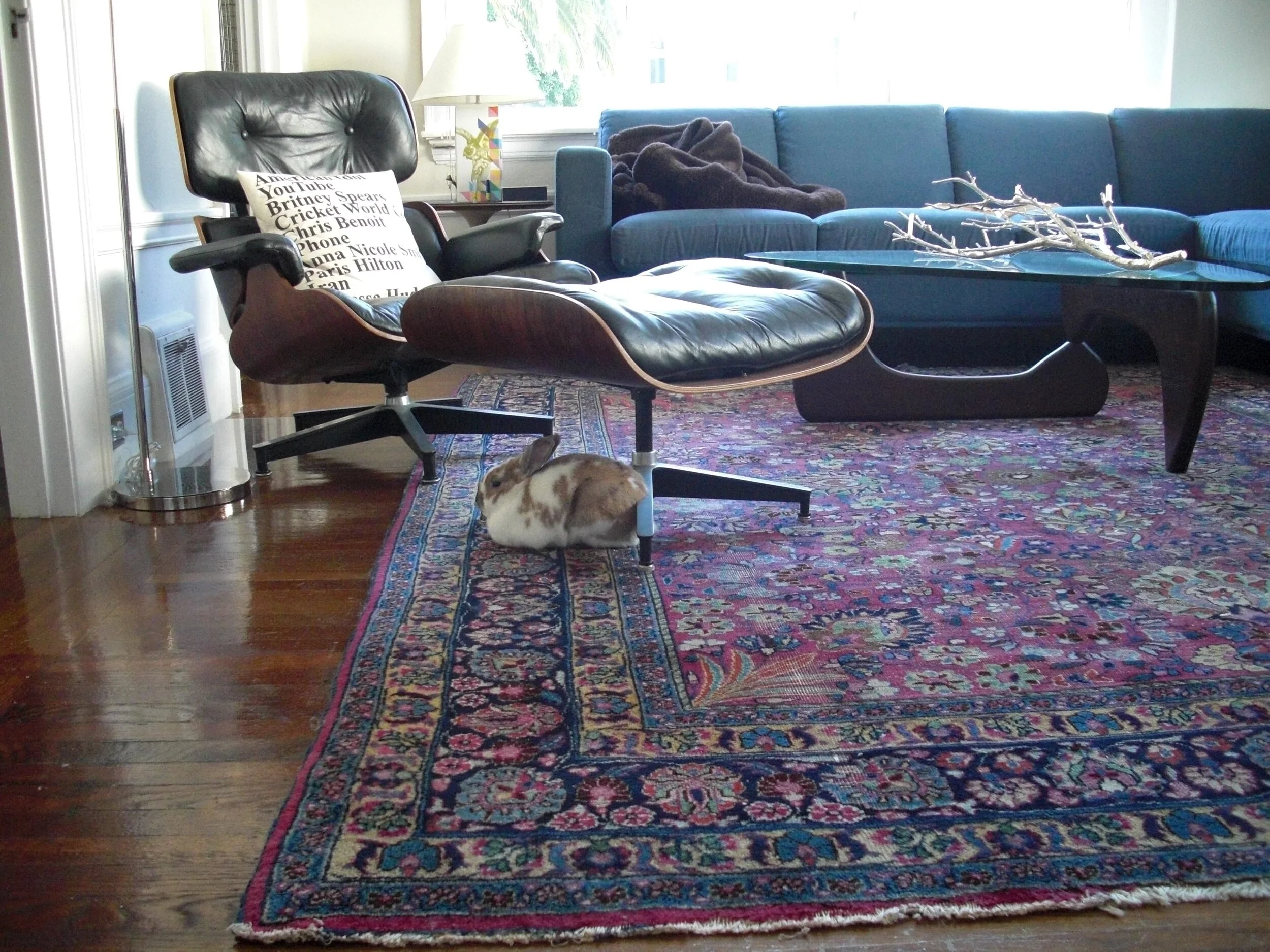 Eames lounger and ottoman given to me from my parents as they no longer had room for it. Pillow is Google’s top searches for 2007 from Etsy.
