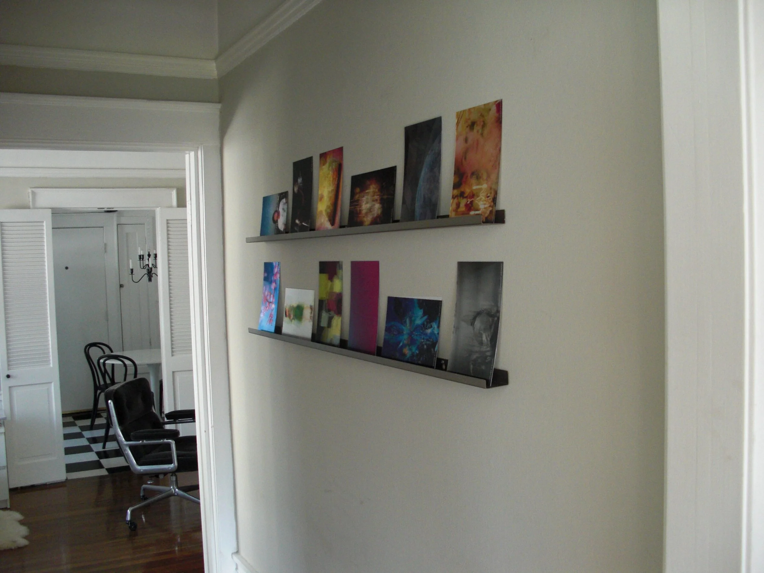 Ledge display from CB2 holds lenticular art from Visionaire 48