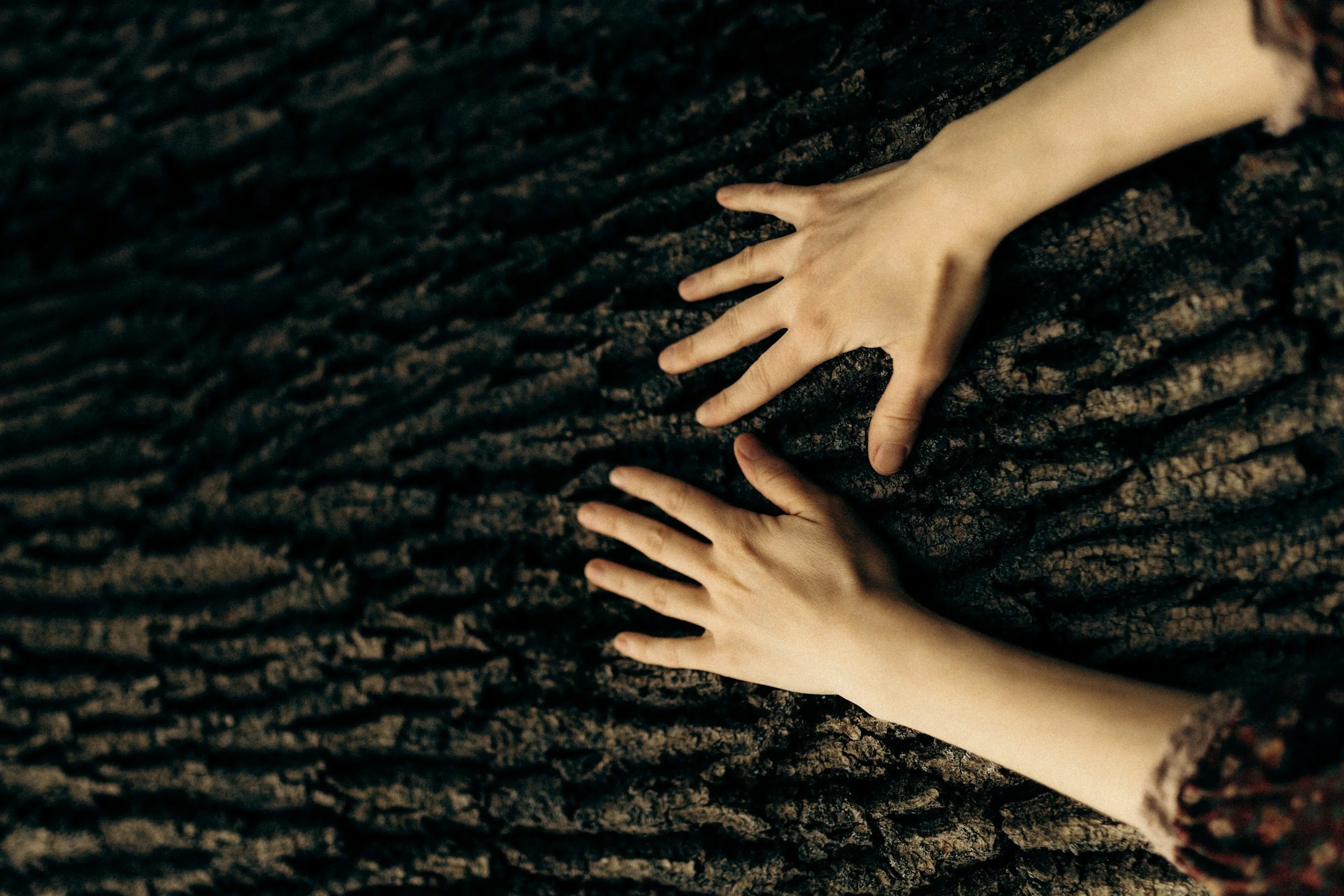 Hands resting on a soft textured fabric