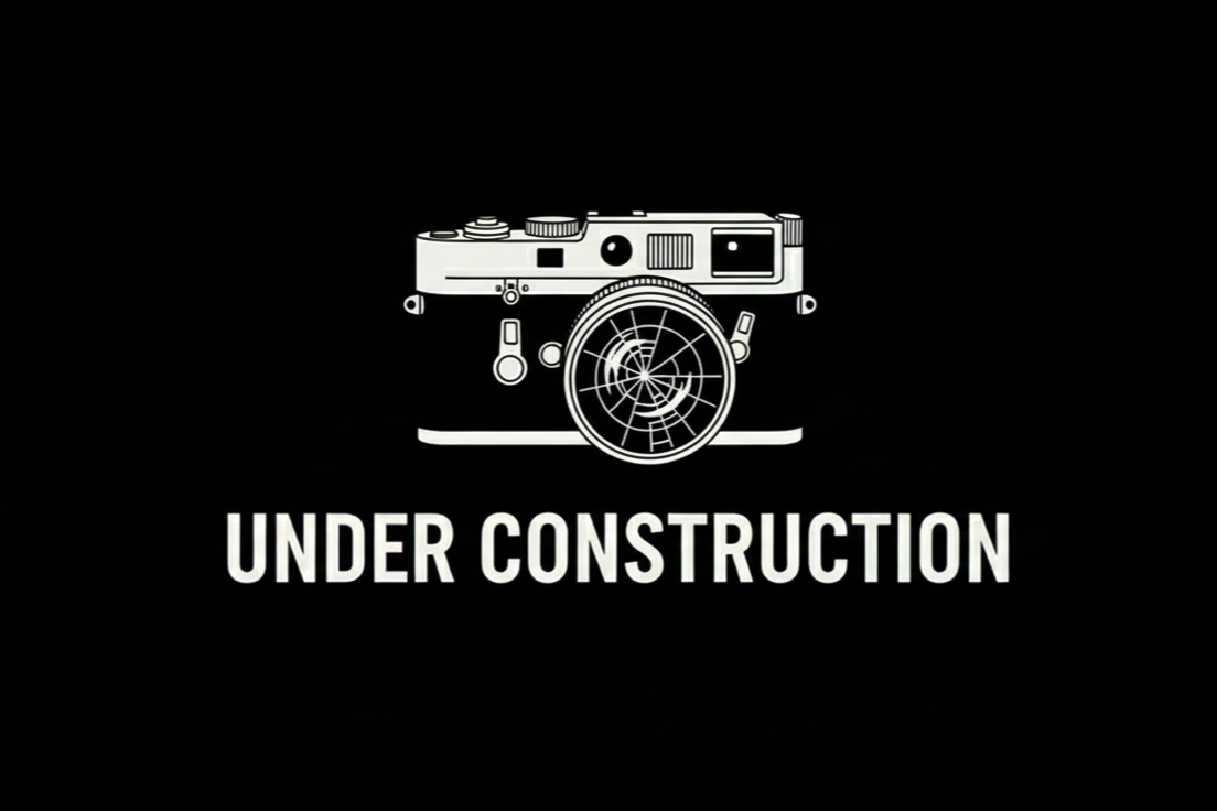 Black background with a white line drawing of a camera above the bold text 'Under Construction'.