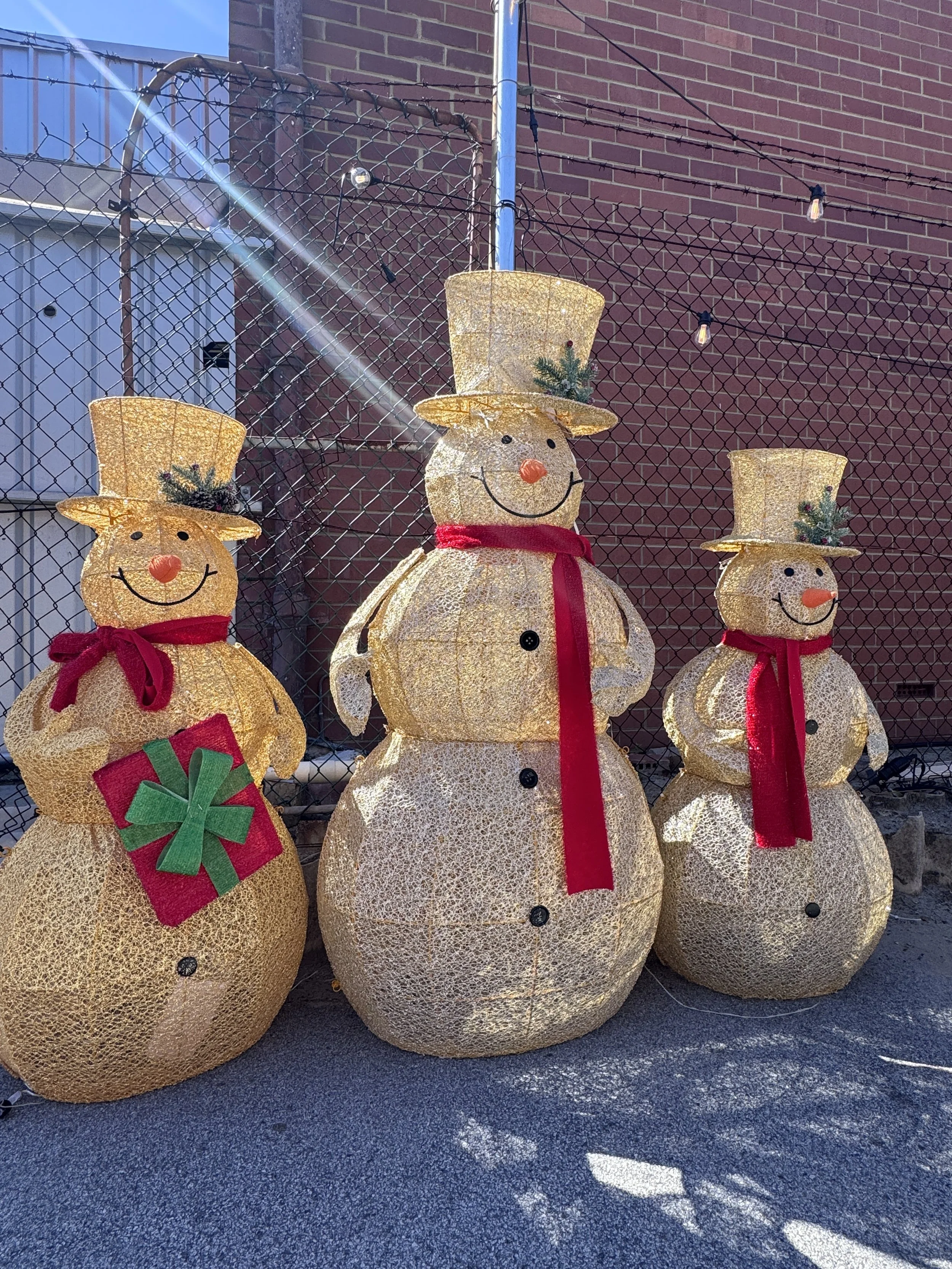 Trio of lighted wire-frame snowmen