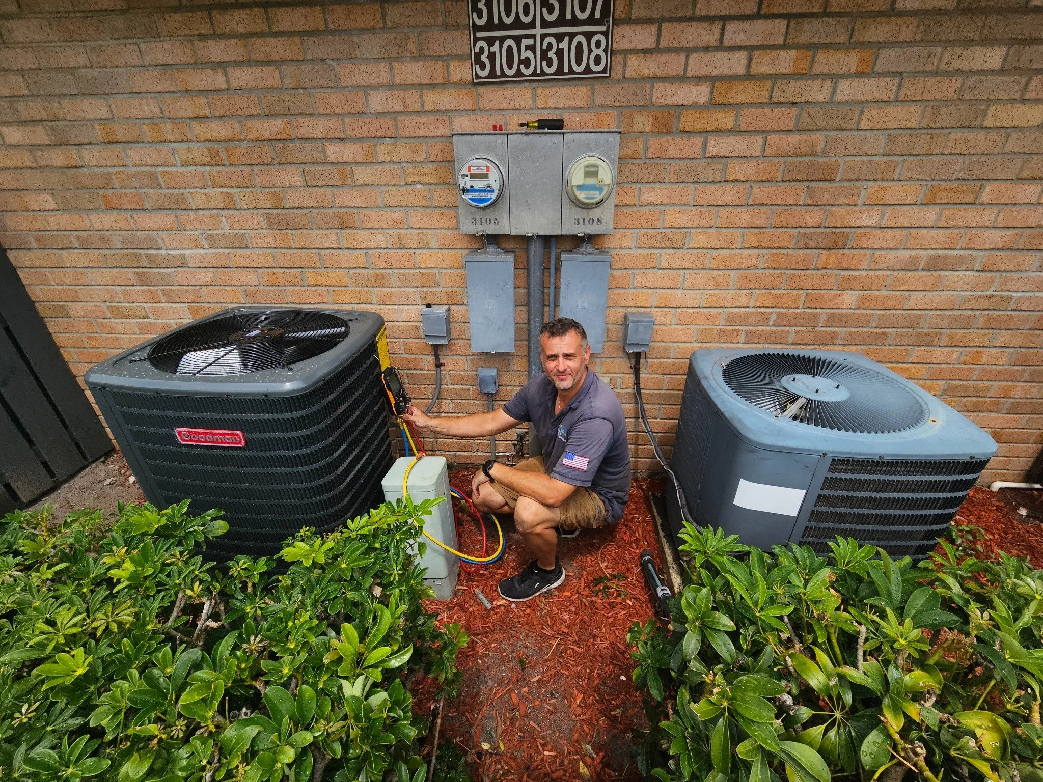 Technician working beside the outdoor equipment during the West Palm Beach AC installation.