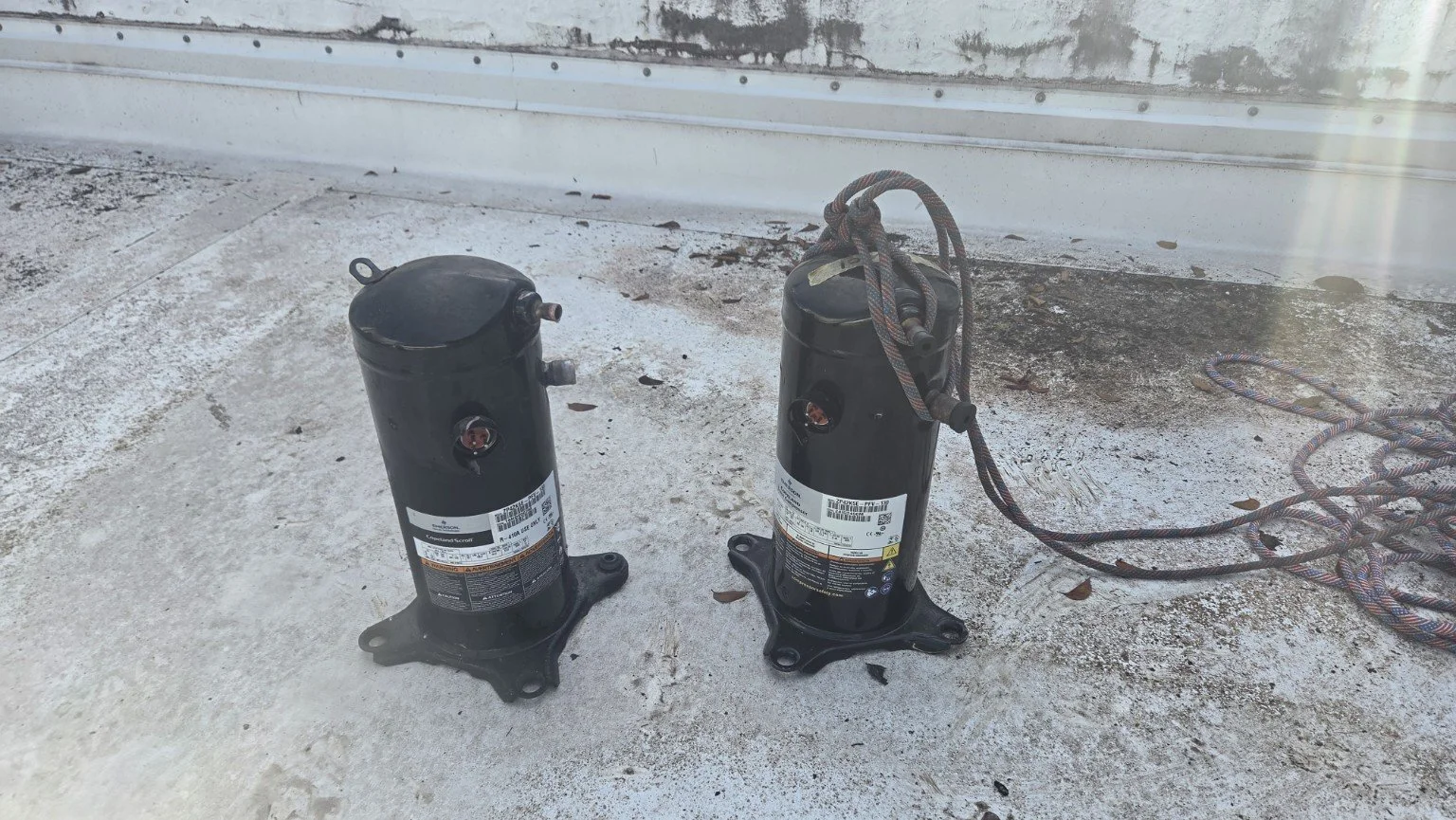 Removed and replacement compressors during a commercial package AC repair in Plantation, Florida.