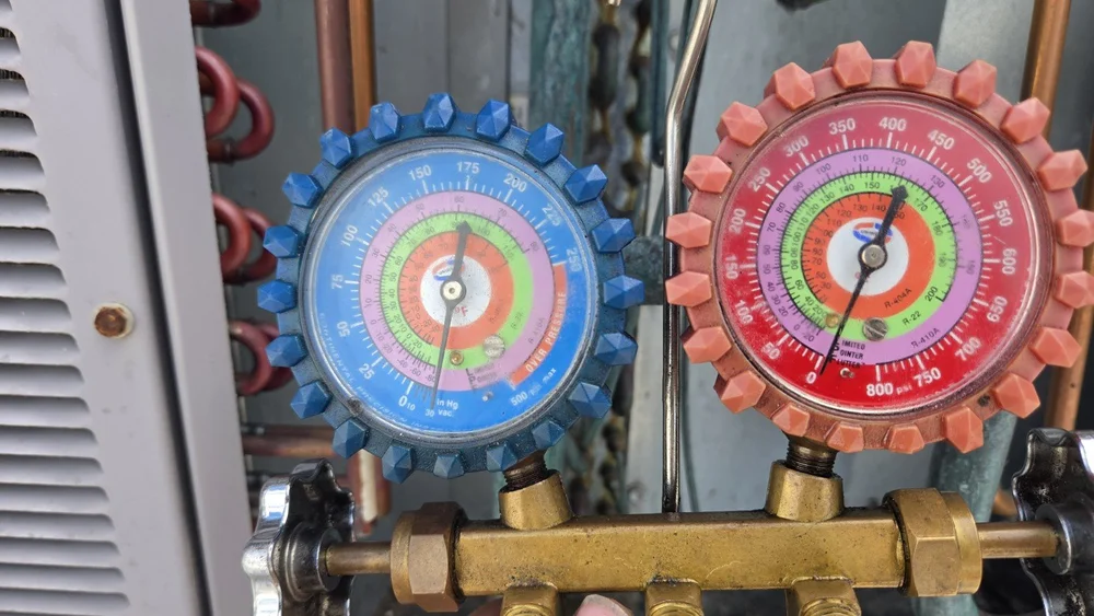 Refrigerant gauges connected during commercial package AC compressor replacement in Plantation, Florida.