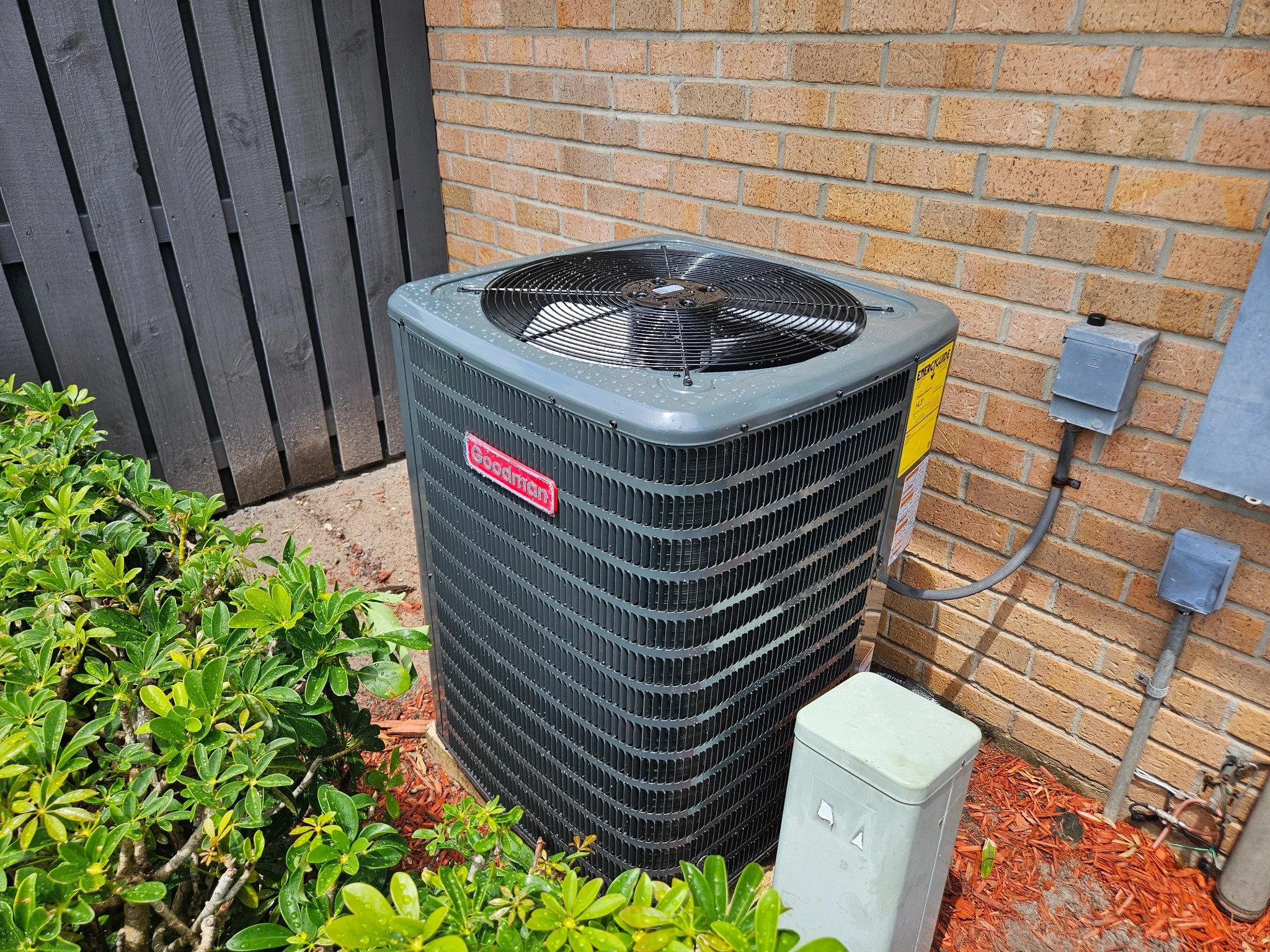 Installed outdoor Goodman condenser in West Palm Beach, Florida.