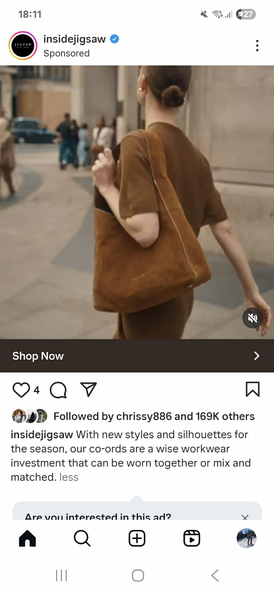 A female model with a low bun wears a brown co-ord accessorised with a brown suede tote bag