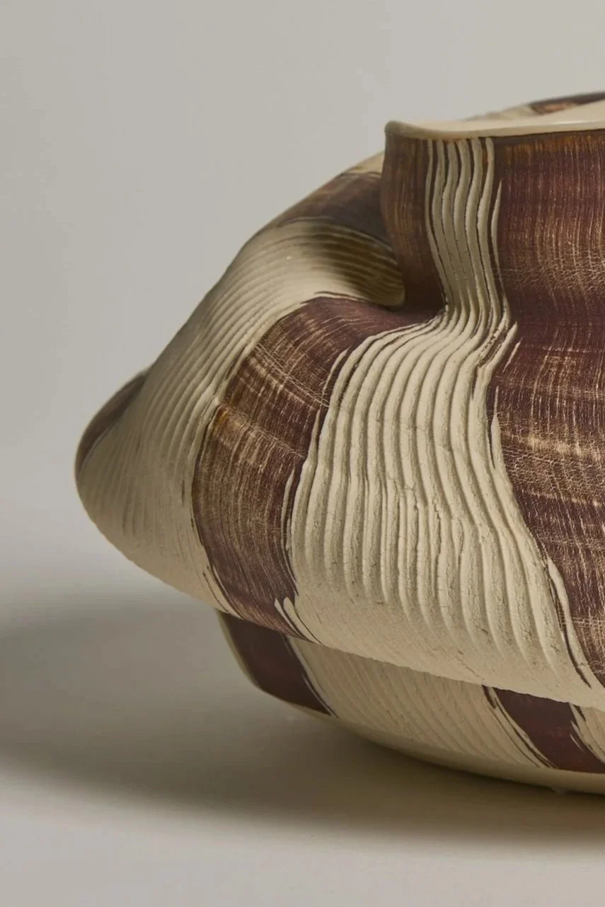 Close-up of sculptural ceramic vessel by Melbourne ceramic artist Alyssa Nuttall, featuring carved organic forms and layered surfaces inspired by coastal landscapes.