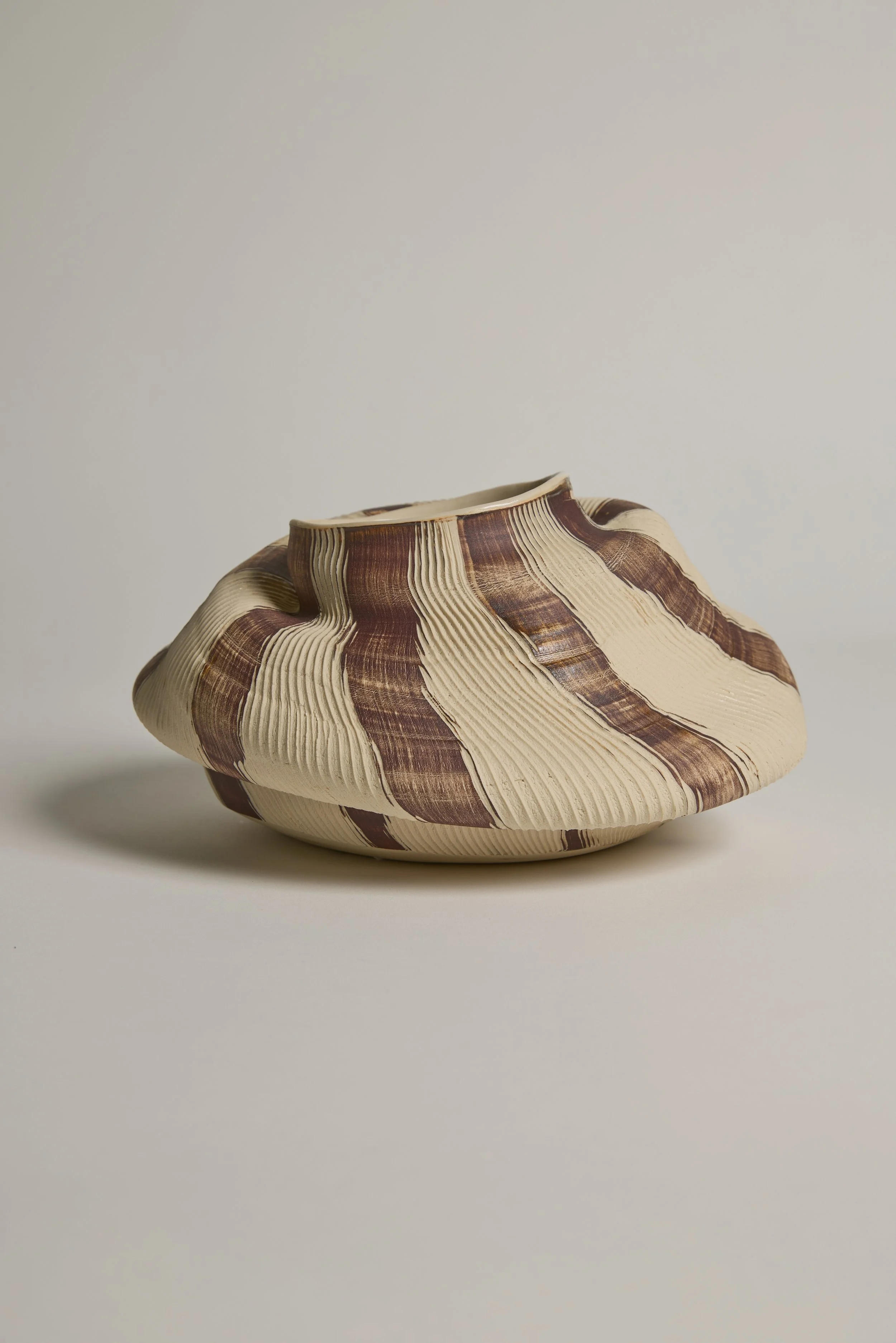 Sculptural ceramic vessel by Melbourne ceramic artist Alyssa Nuttall, featuring carved organic forms and layered surfaces inspired by coastal landscapes.