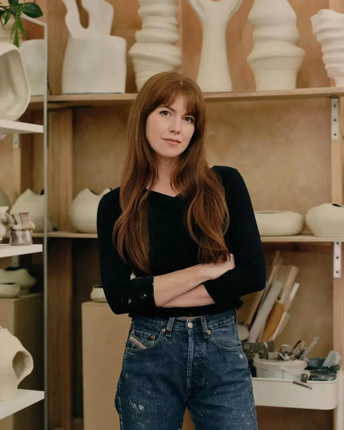 Melbourne ceramic artist Alyssa Nuttall in her pottery studio surrounded by her contemporary ceramic works.